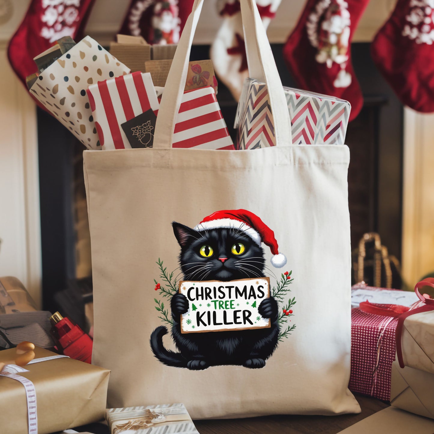 Canvas tote bag with a black cat in a Santa hat holding a “Christmas Tree Killer” sign, shown on a Christmas themed background