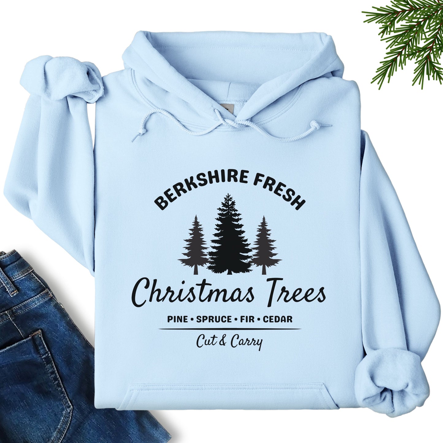 Berkshire Fresh Christmas Trees hoodie in light blue laid flat showing festive tree farm graphic on the front