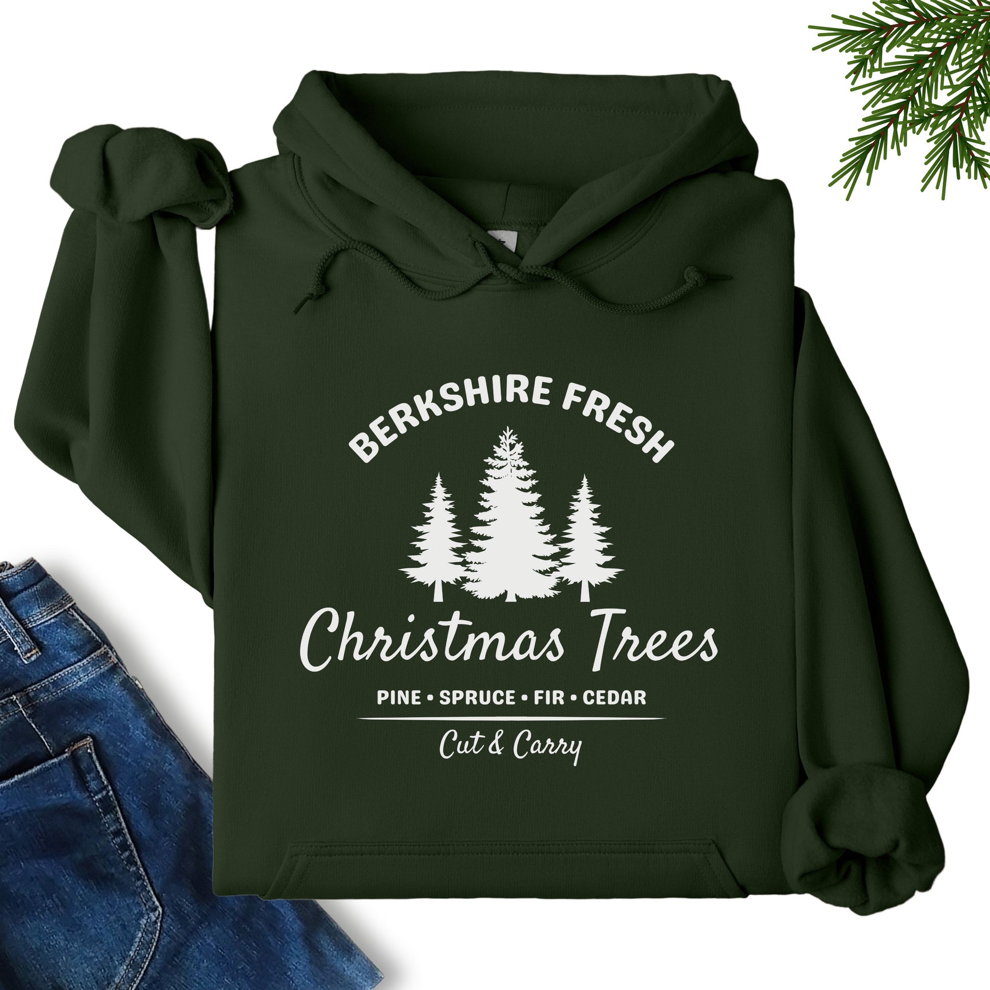 Berkshire Fresh Christmas Trees hoodie in forest green laid flat showing festive tree farm graphic on the front