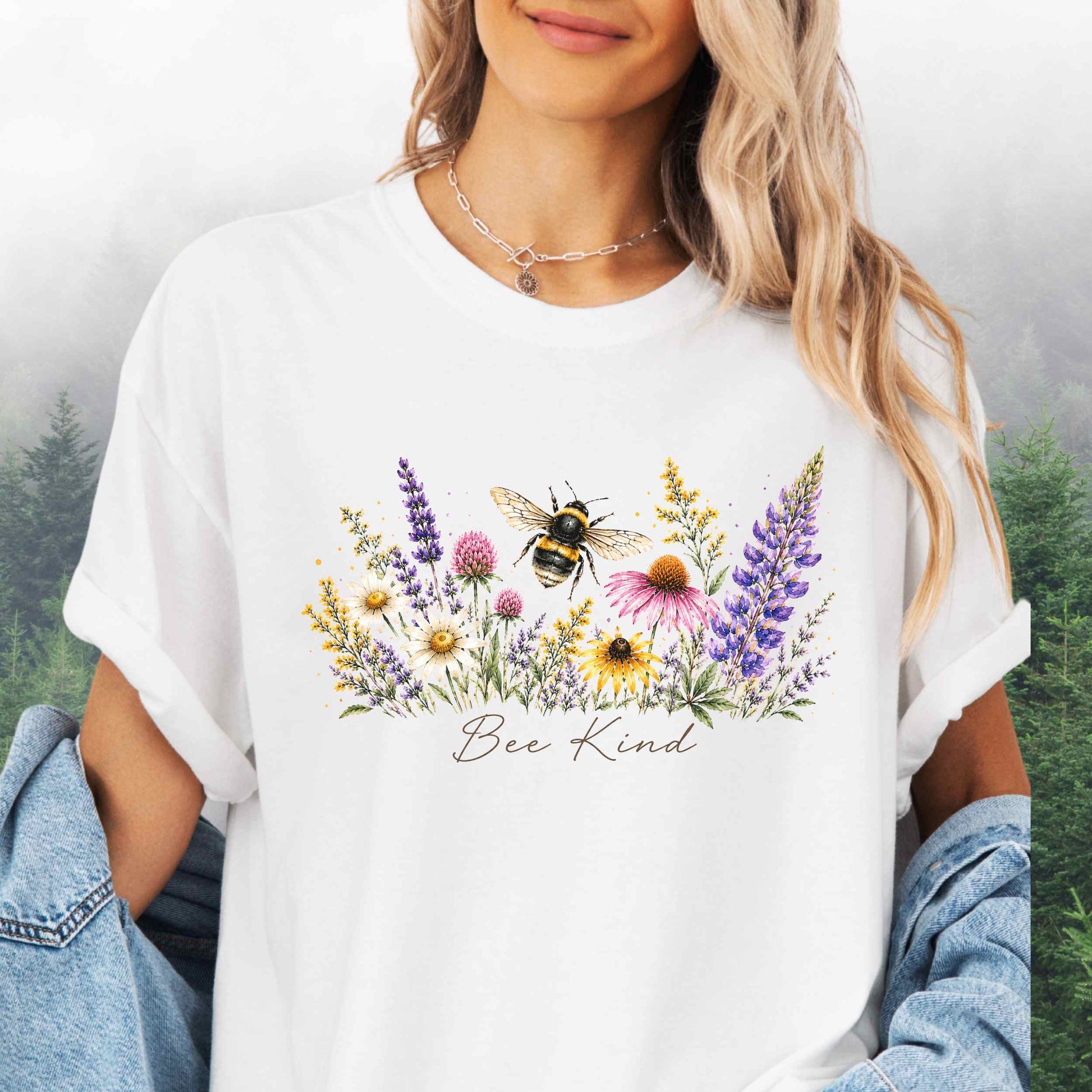 Person wearing Bee Kind Comfort Colors t-shirt with watercolor bee and wildflowers in the color white.