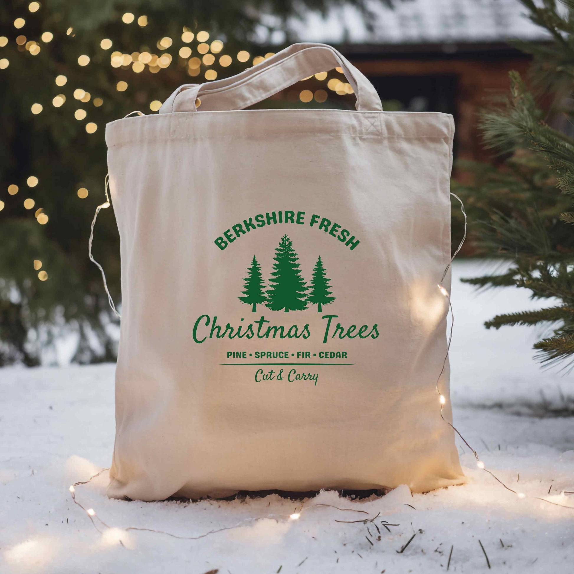 Canvas tote bag with 'Berkshire Fresh Christmas Trees' text and tree graphics on a snowy background.