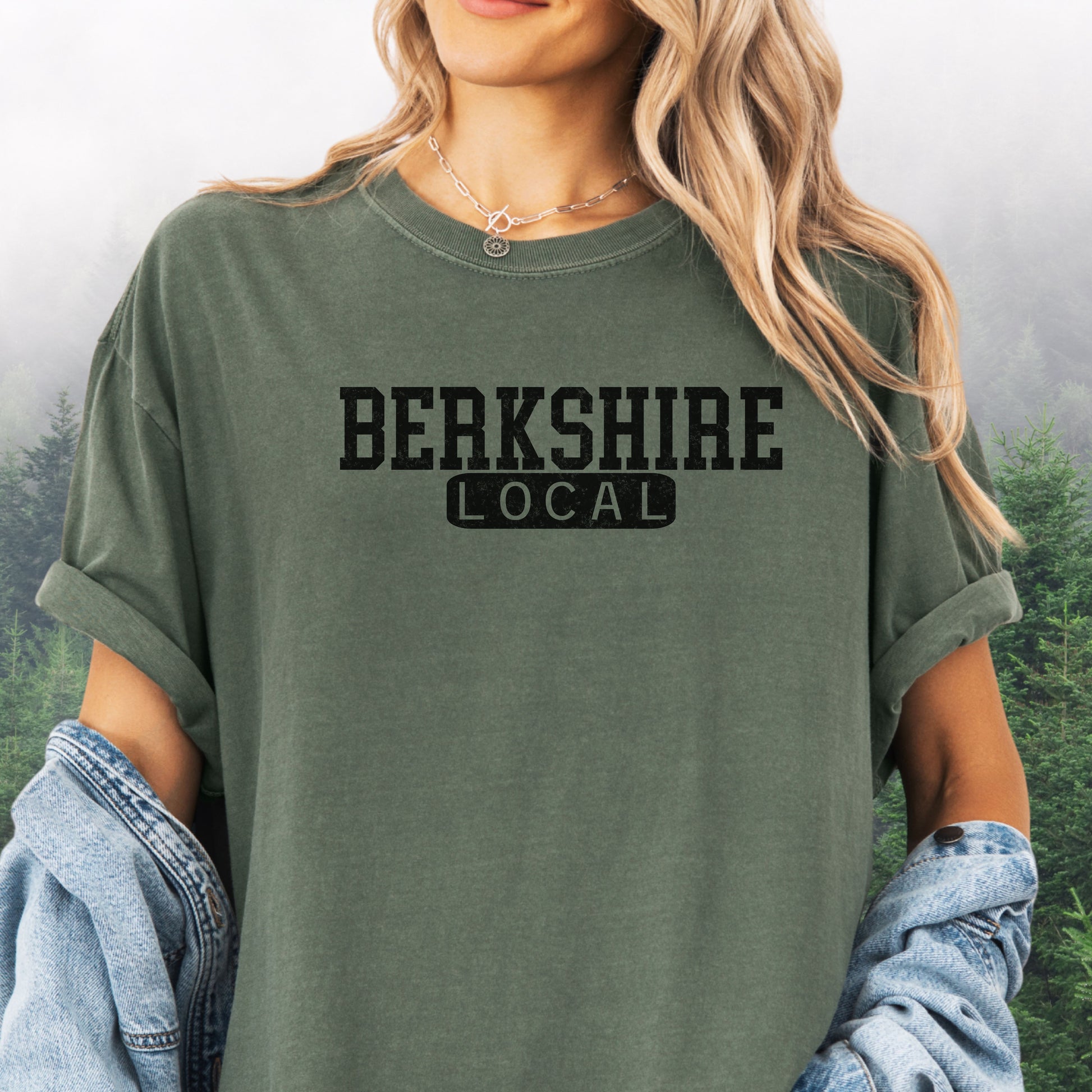 Person wearing Berkshire Local vintage distressed graphic on a moss Comfort Colors t shirt