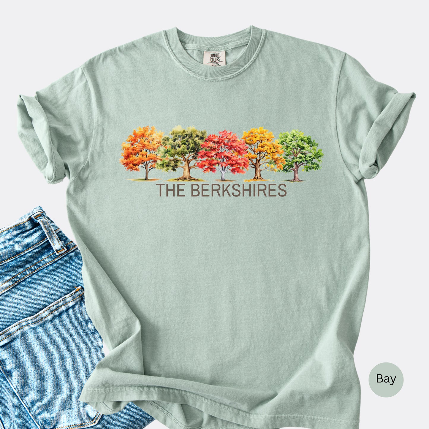 Flat Lay of The Berkshires Fall Comfort Colors t-shirt with autumn trees design in the color bay.
