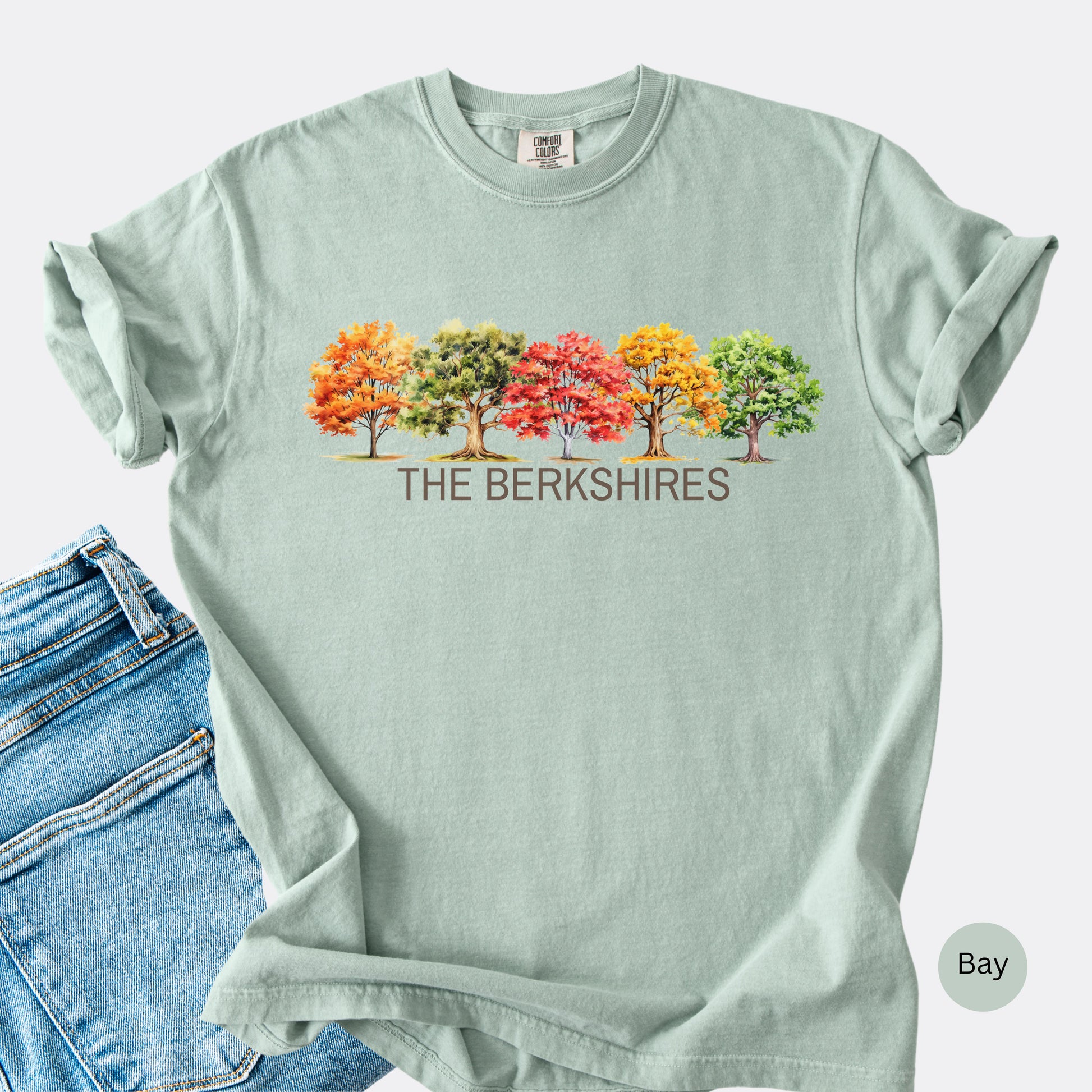 Flat Lay of The Berkshires Fall Comfort Colors t-shirt with autumn trees design in the color bay.