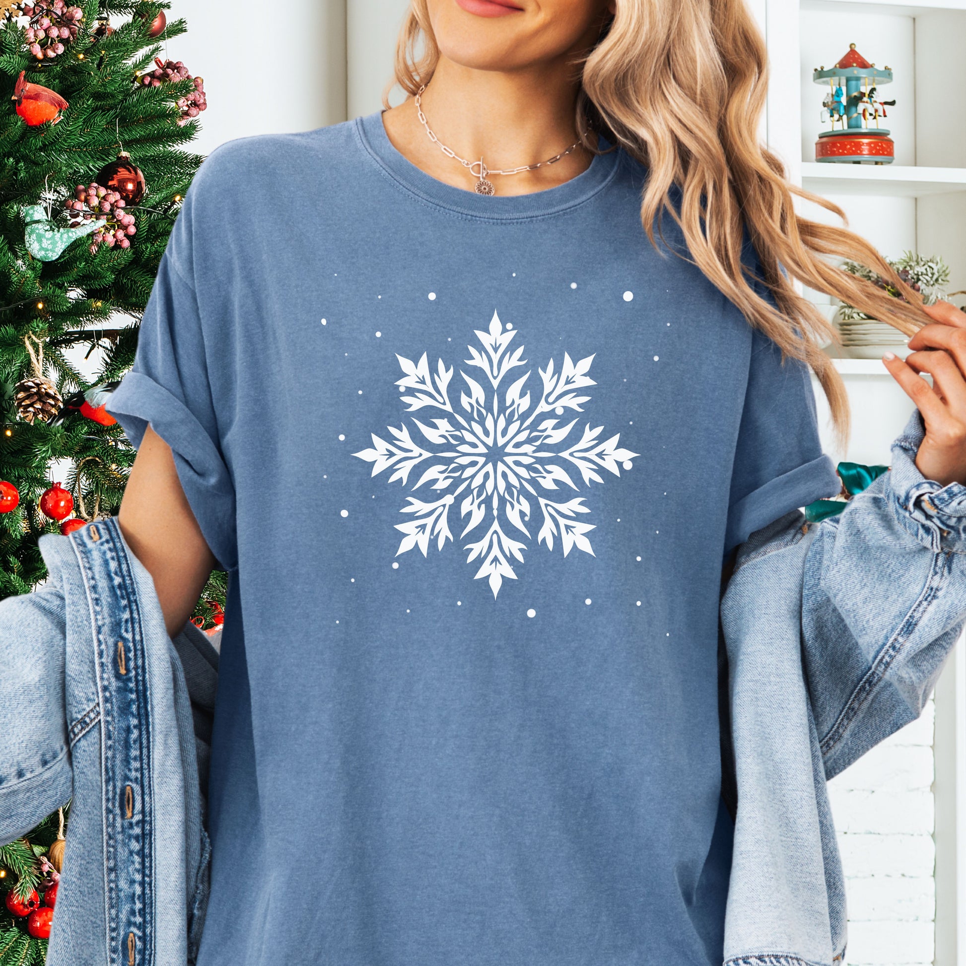 Person wearing a Comfort Colors tshirt with snowflake design in the color blue jean