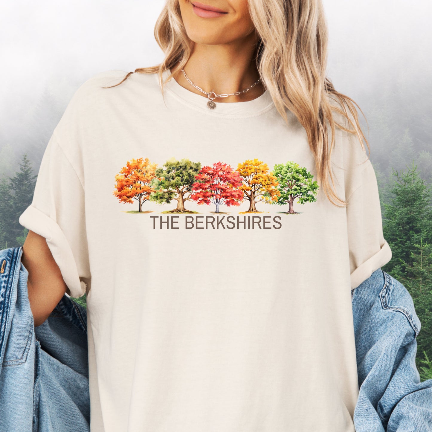 Person wearing The Berkshires Fall Comfort Colors t-shirt with autumn trees design in the color ivory
