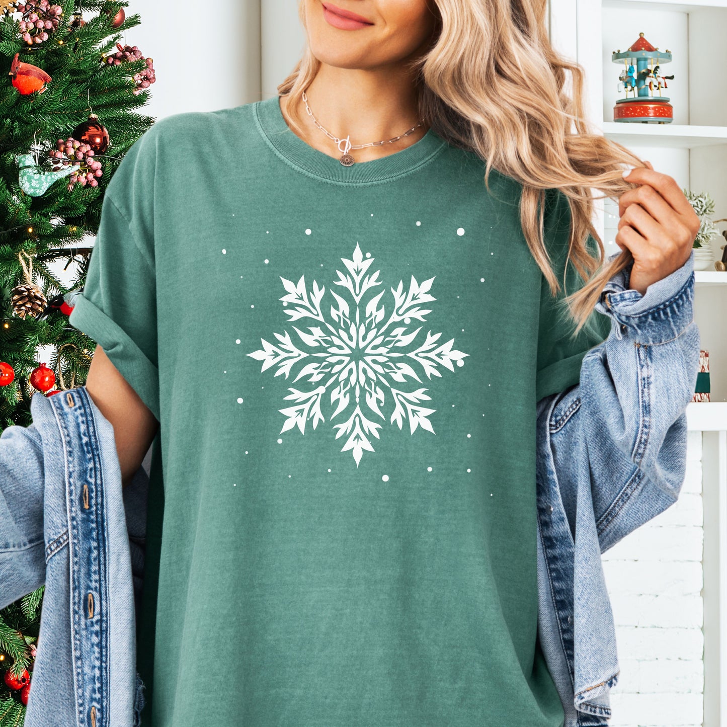 Person wearing a Comfort Colors tshirt with snowflake design in the color light green