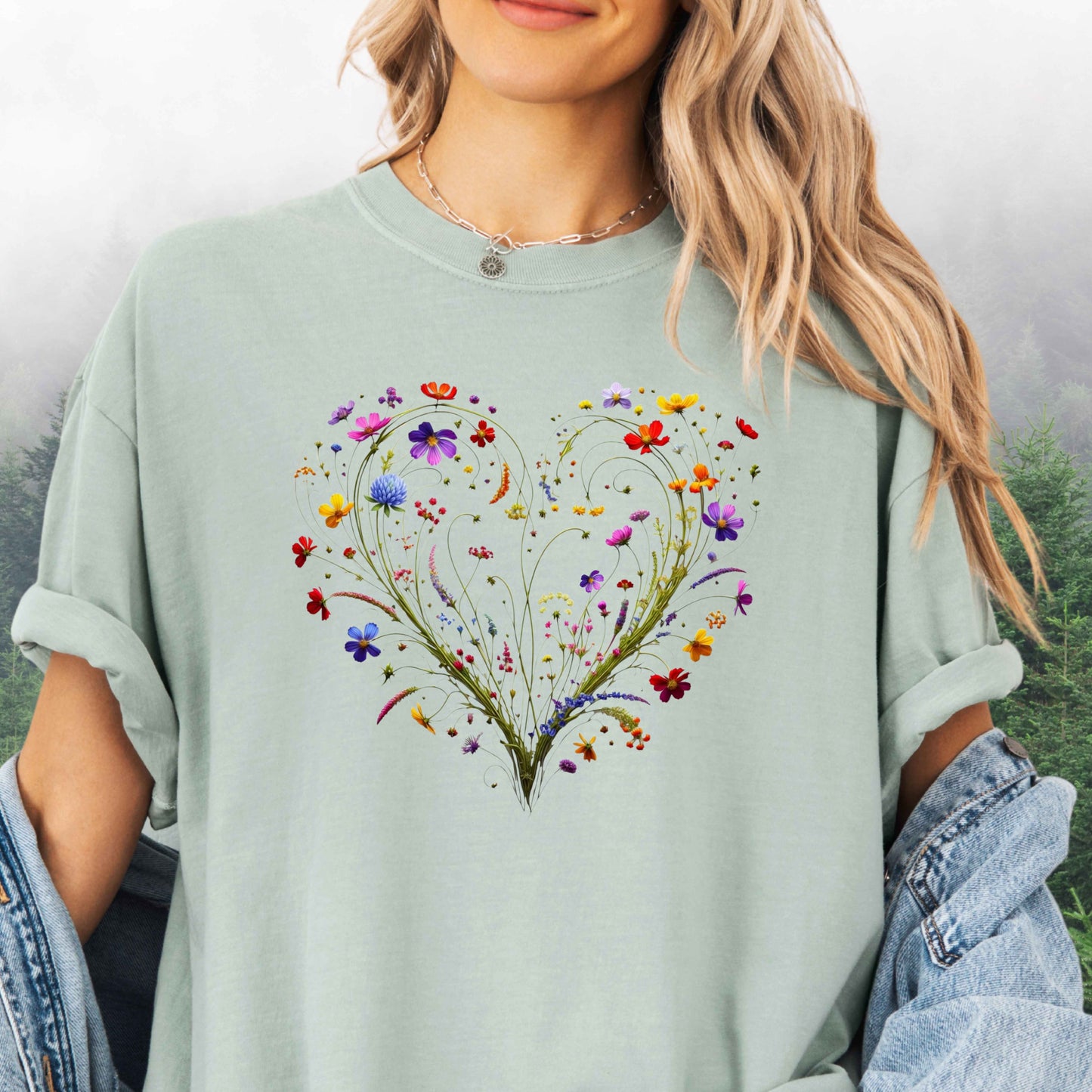 Person wearing a bay colored shirt with a wildflower heart graphic