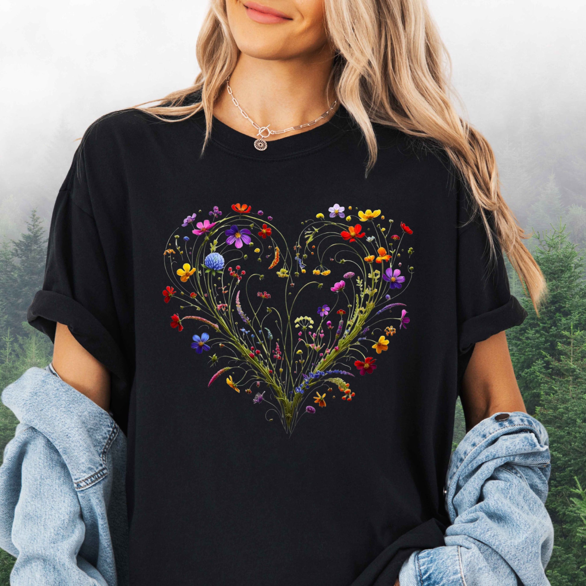 Person wearing a black shirt with a wildflower heart graphic