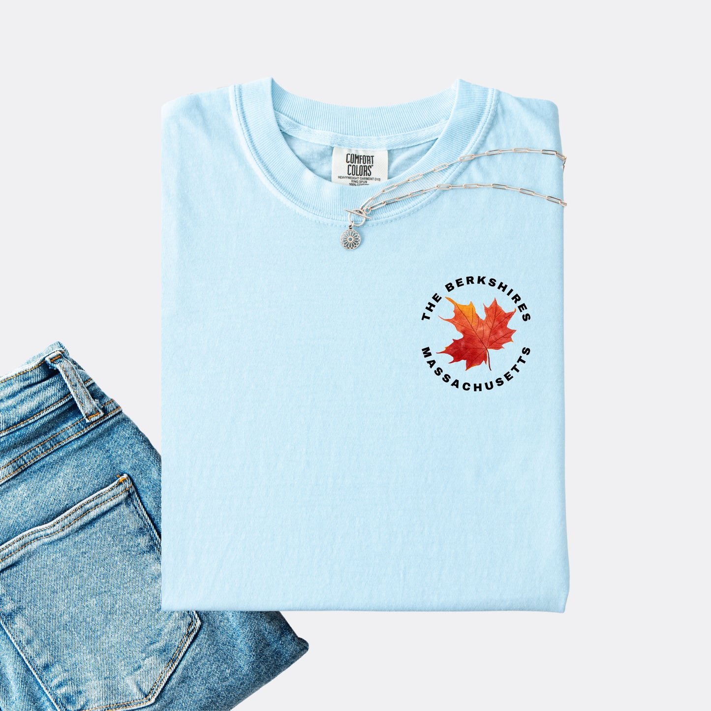 Comfort Colors T-shirt in the color chambray. The front chest design features a red maple leaf with text reading ‘The Berkshires Massachusetts.’”