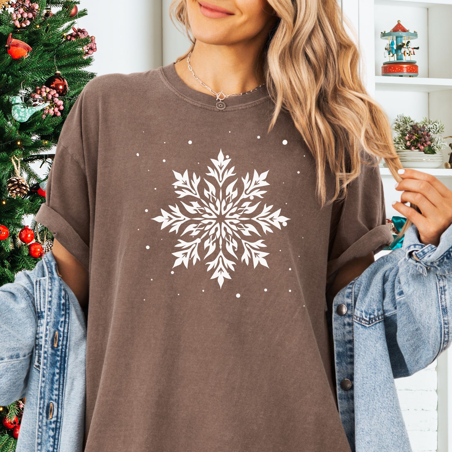 Person wearing a Comfort Colors tshirt with snowflake design in the color expresso