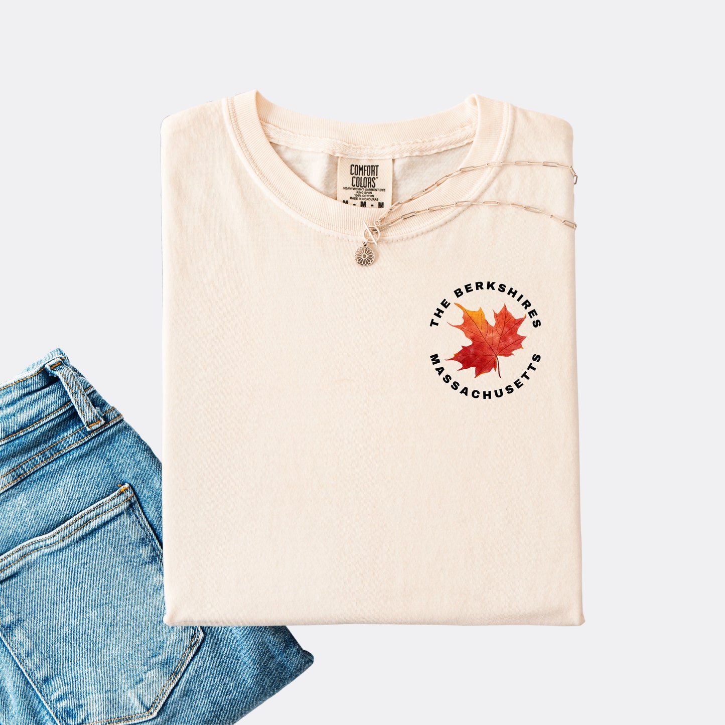 Comfort Colors T-shirt in the color ivory. The front chest design features a red maple leaf with text reading ‘The Berkshires Massachusetts.’”