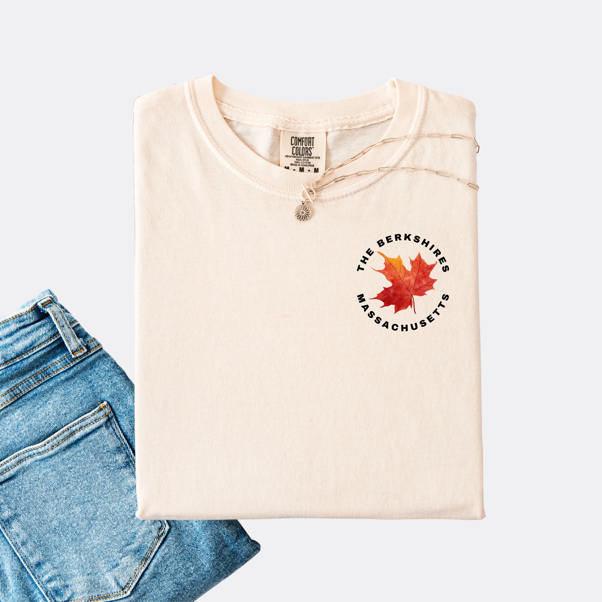 Comfort Colors T-shirt in the color ivory. The front chest design features a red maple leaf with text reading ‘The Berkshires Massachusetts.’”