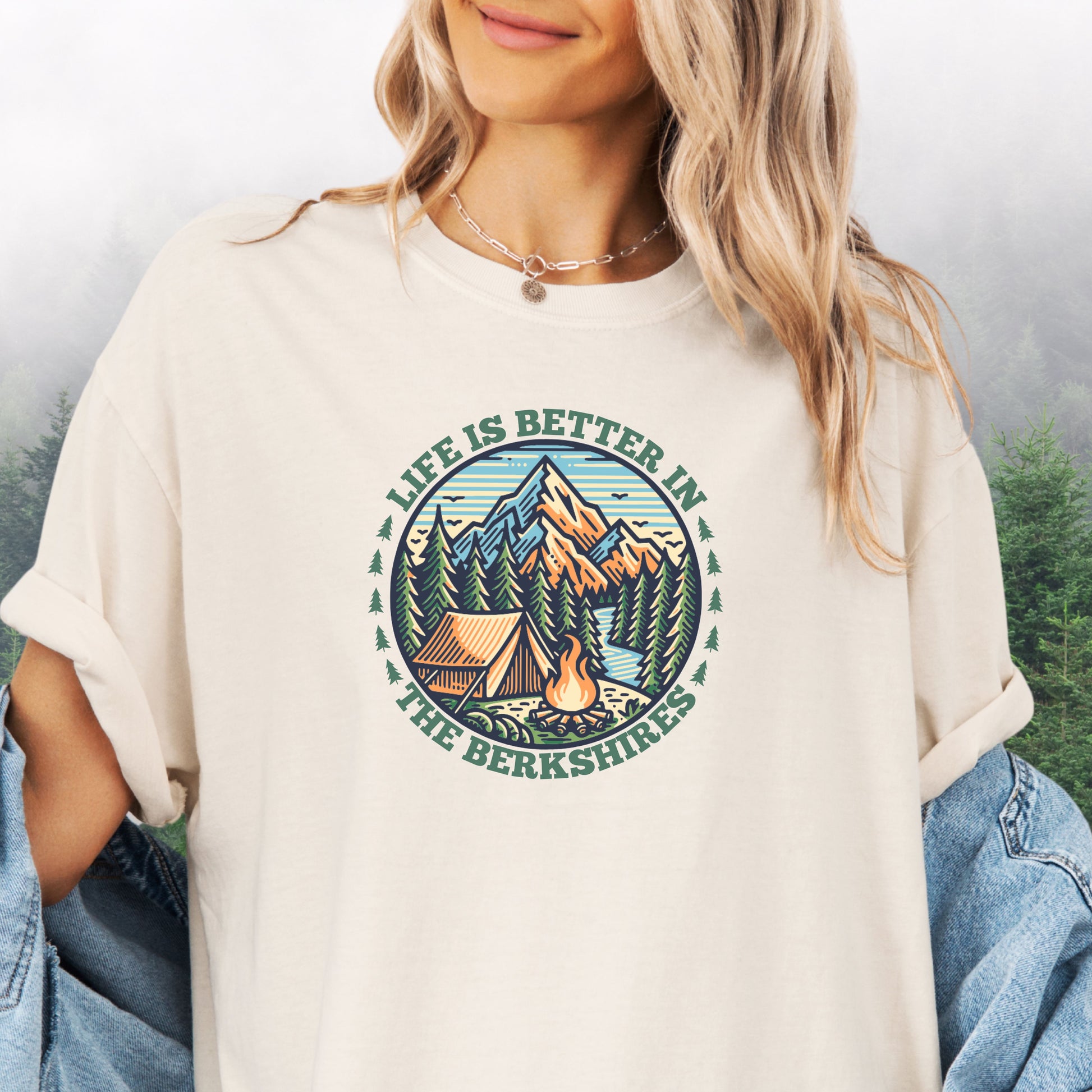 Person wearing ivory colored Comfort Colors shirt with mountain design and the text: Life Is Better In The Berkshires