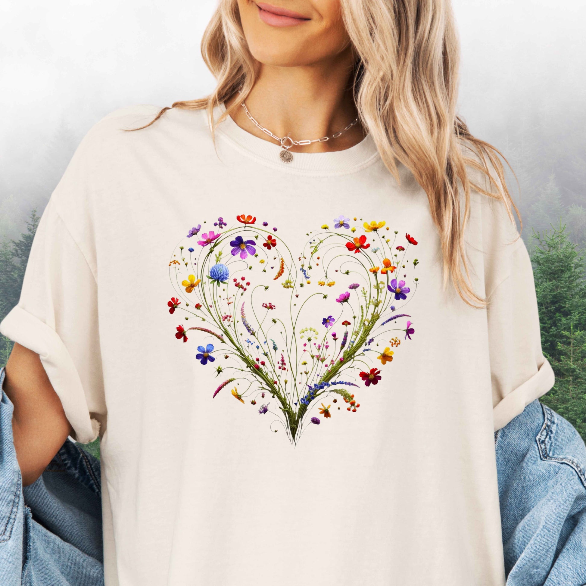 Person wearing an ivory shirt with a wildflower heart graphic