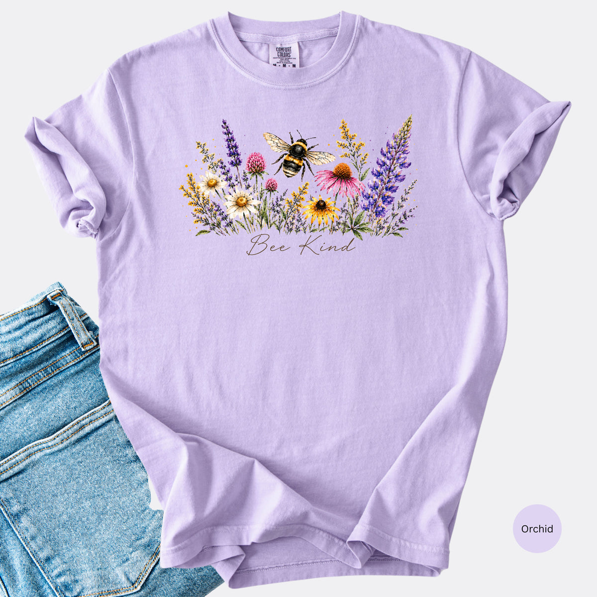 Bee Kind Comfort Colors t-shirt with watercolor bee and wildflowers in the color orchard.