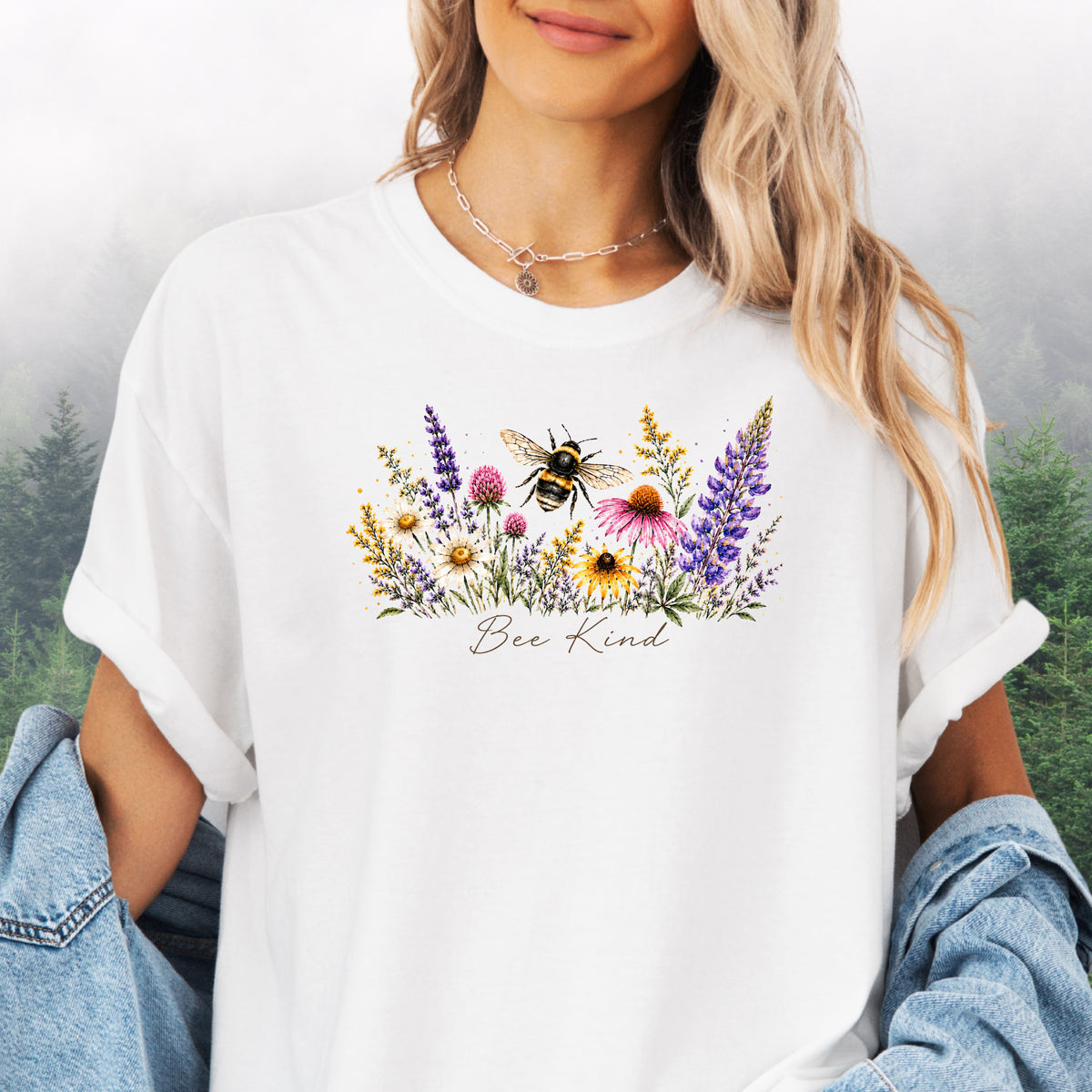 Person wearing Bee Kind Comfort Colors t-shirt with watercolor bee and wildflowers in the color white.