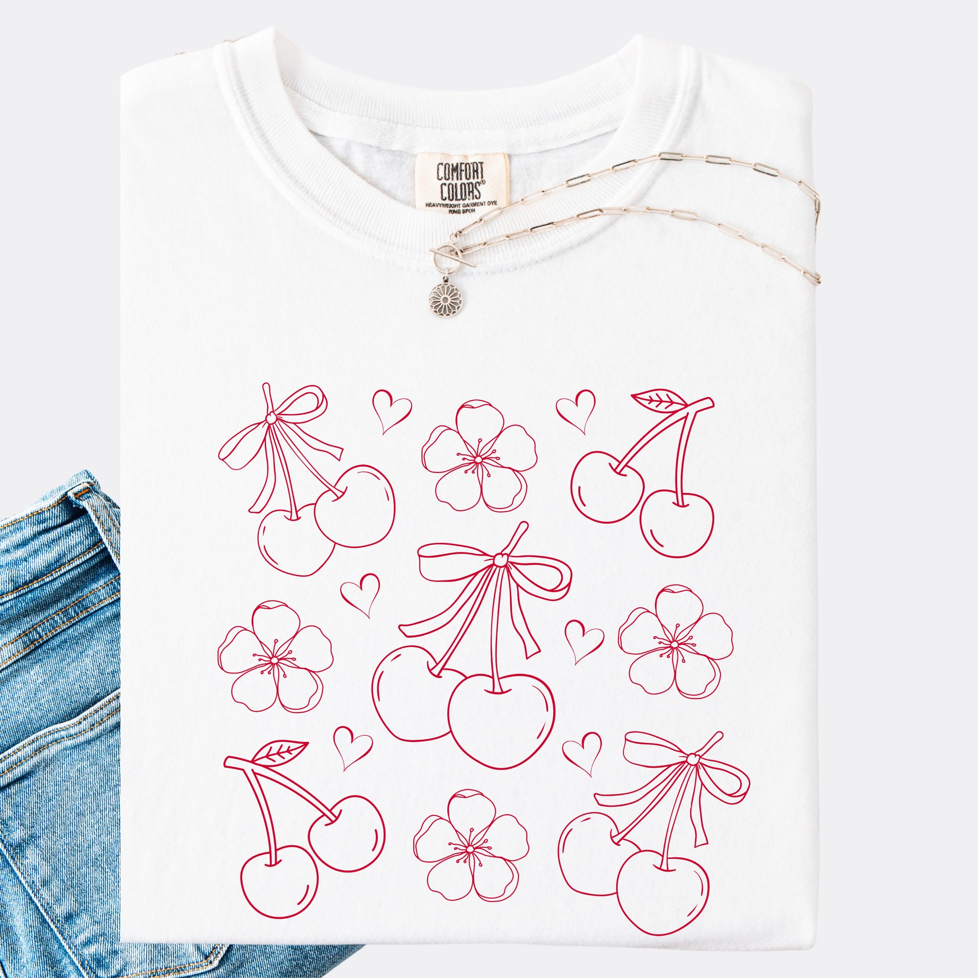 Comfort Colors shirt in white with graphic of cherries, cherry blossoms and hearts, red ink.