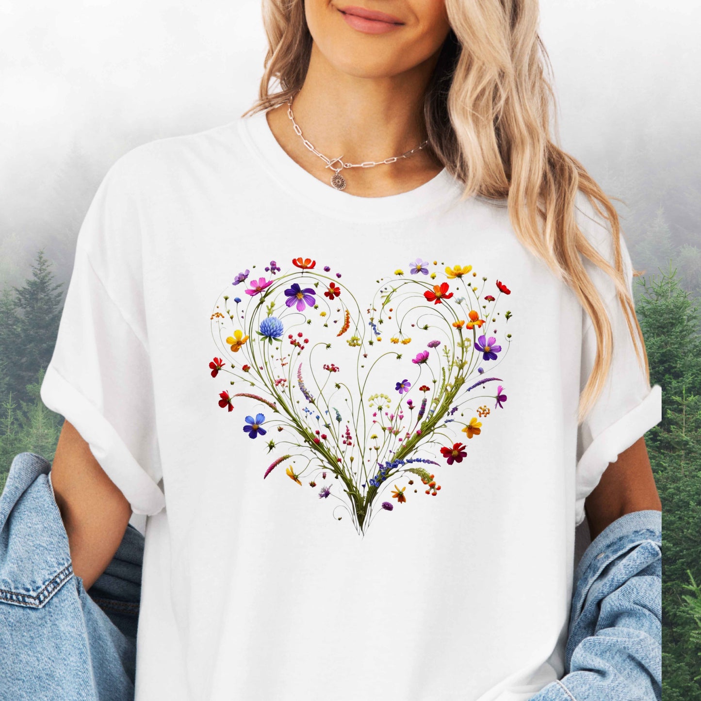 Person wearing a white shirt with a wildflower heart graphic