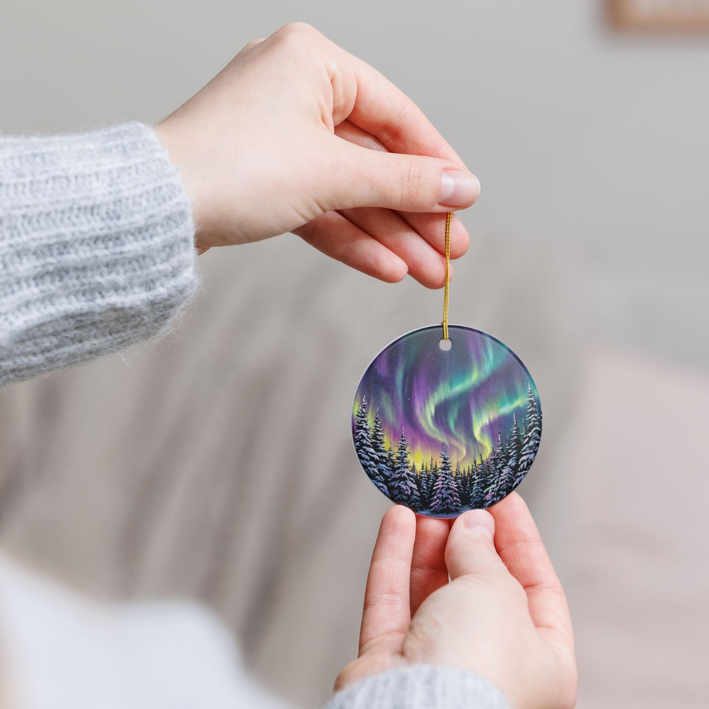 Northern Lights Christmas ornament with snowy evergreen forest and glowing winter night sky