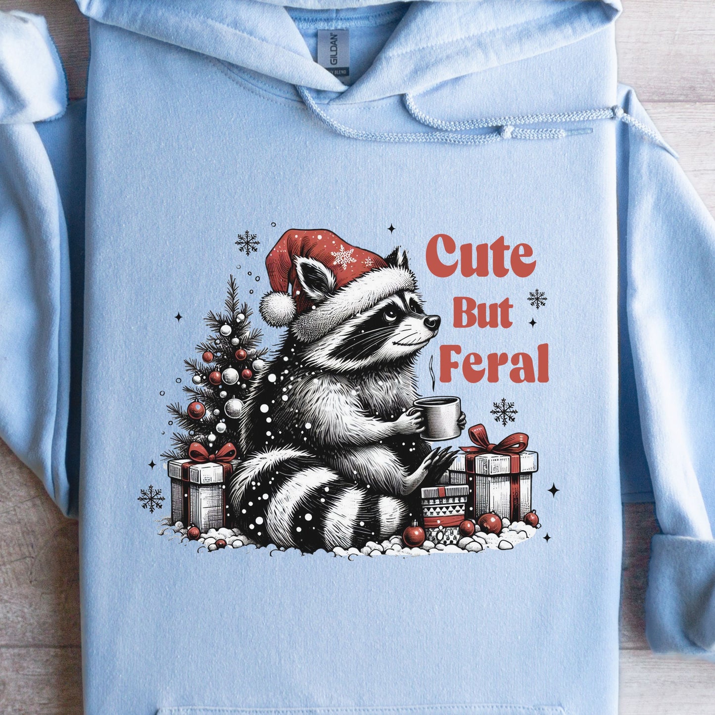 Cute But Feral Hooded Sweatshirt with racoon flat lay light blue color