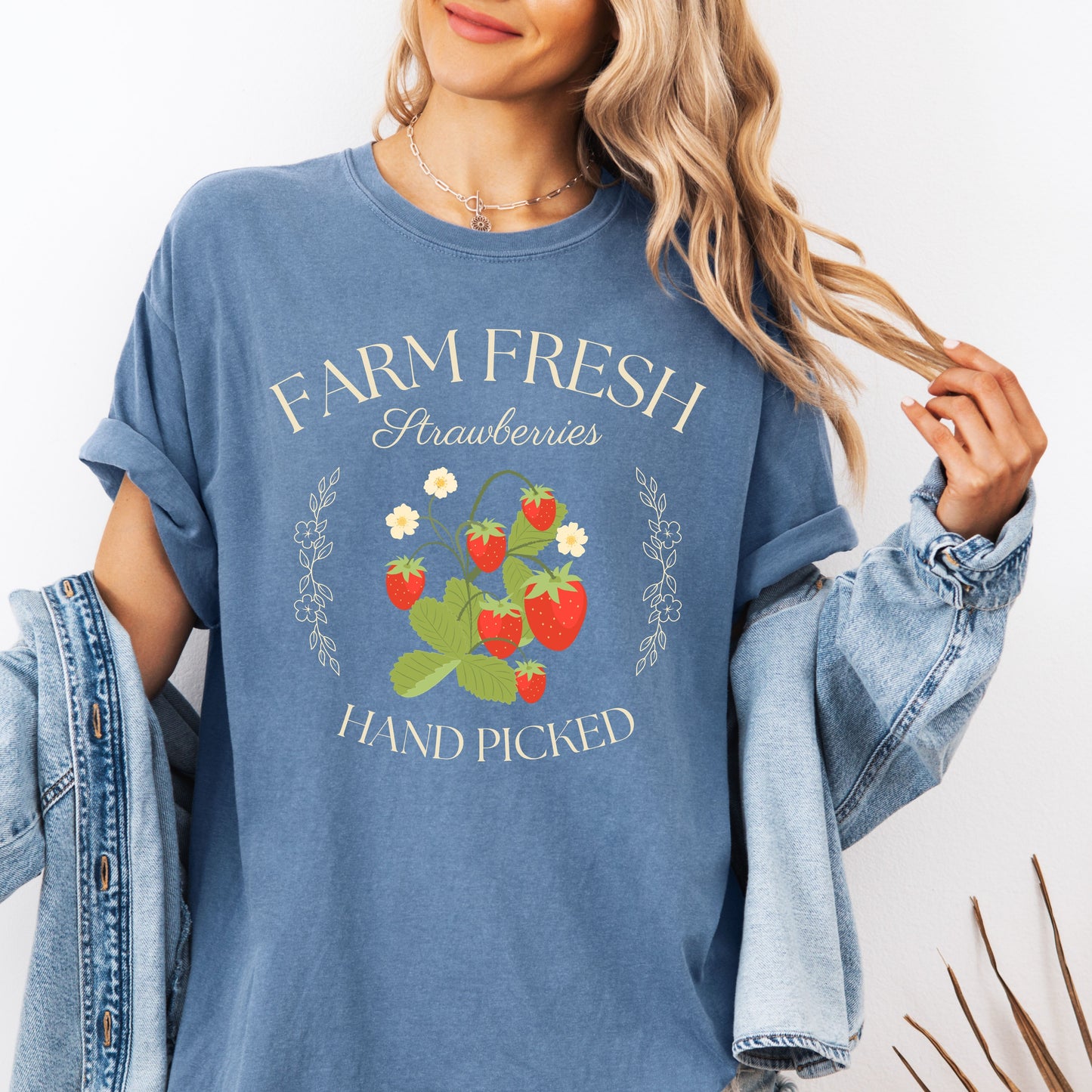 Person wearing a Blue Jean t-shirt with 'Farm Fresh Strawberries Hand Picked' design.