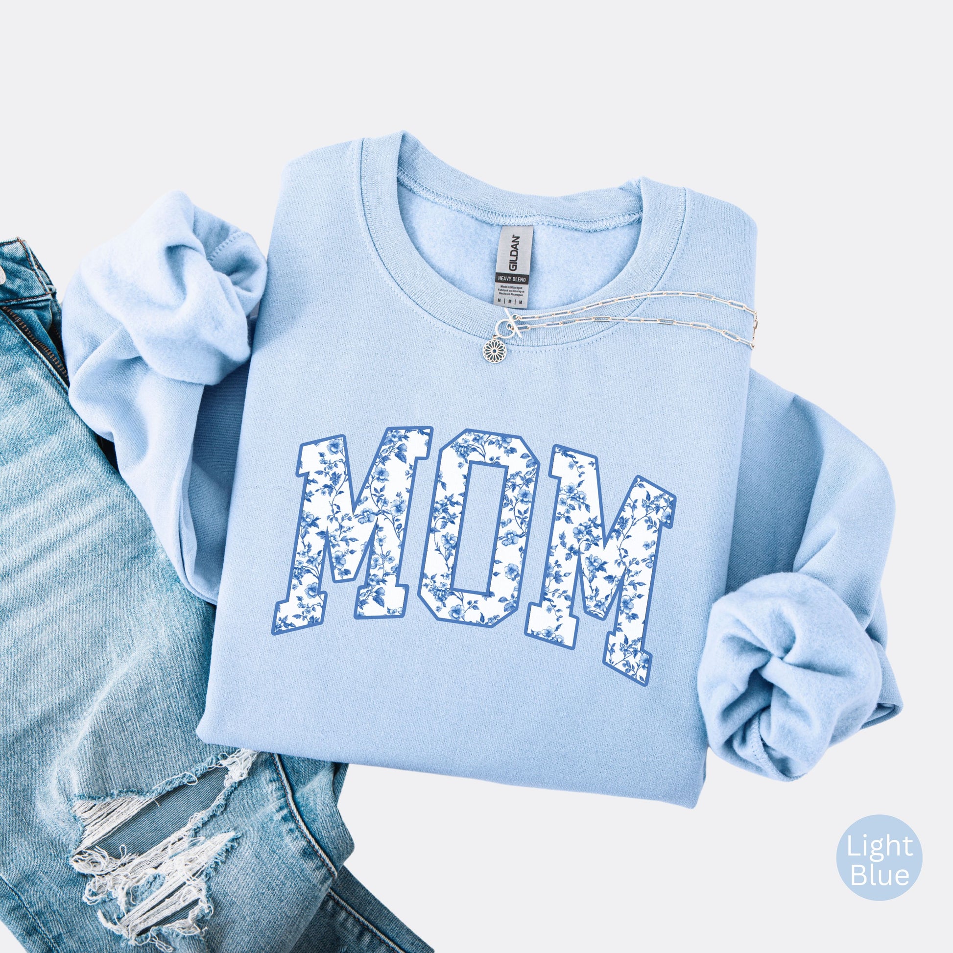 Crewneck sweatshirt with floral MOM lettering on the front and personalized names on the sleeve, light blue