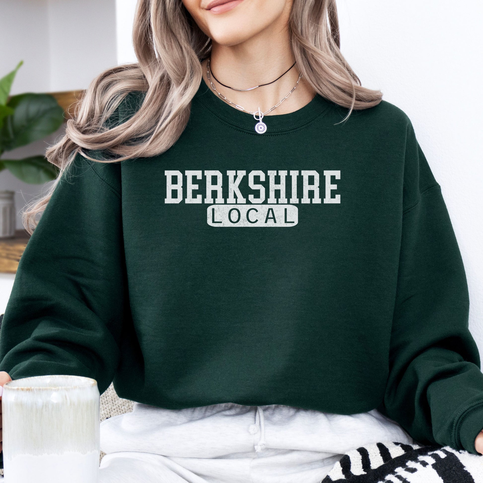 Person wearing Berkshire Local vintage distressed Massachusetts crewneck sweatshirt in the color forest green