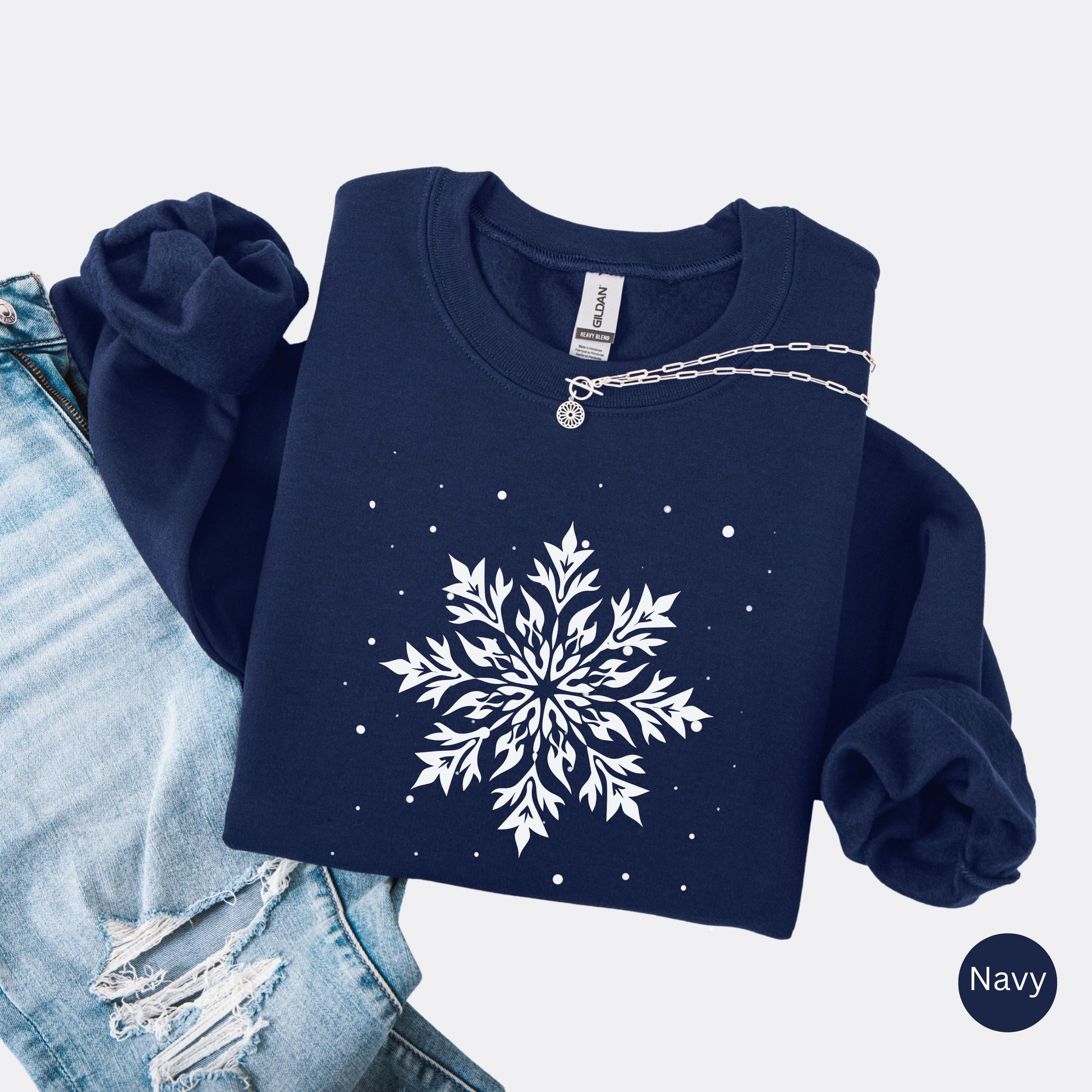 Snowflake design with falling snow on cozy unisex winter sweatshirt in the color navy