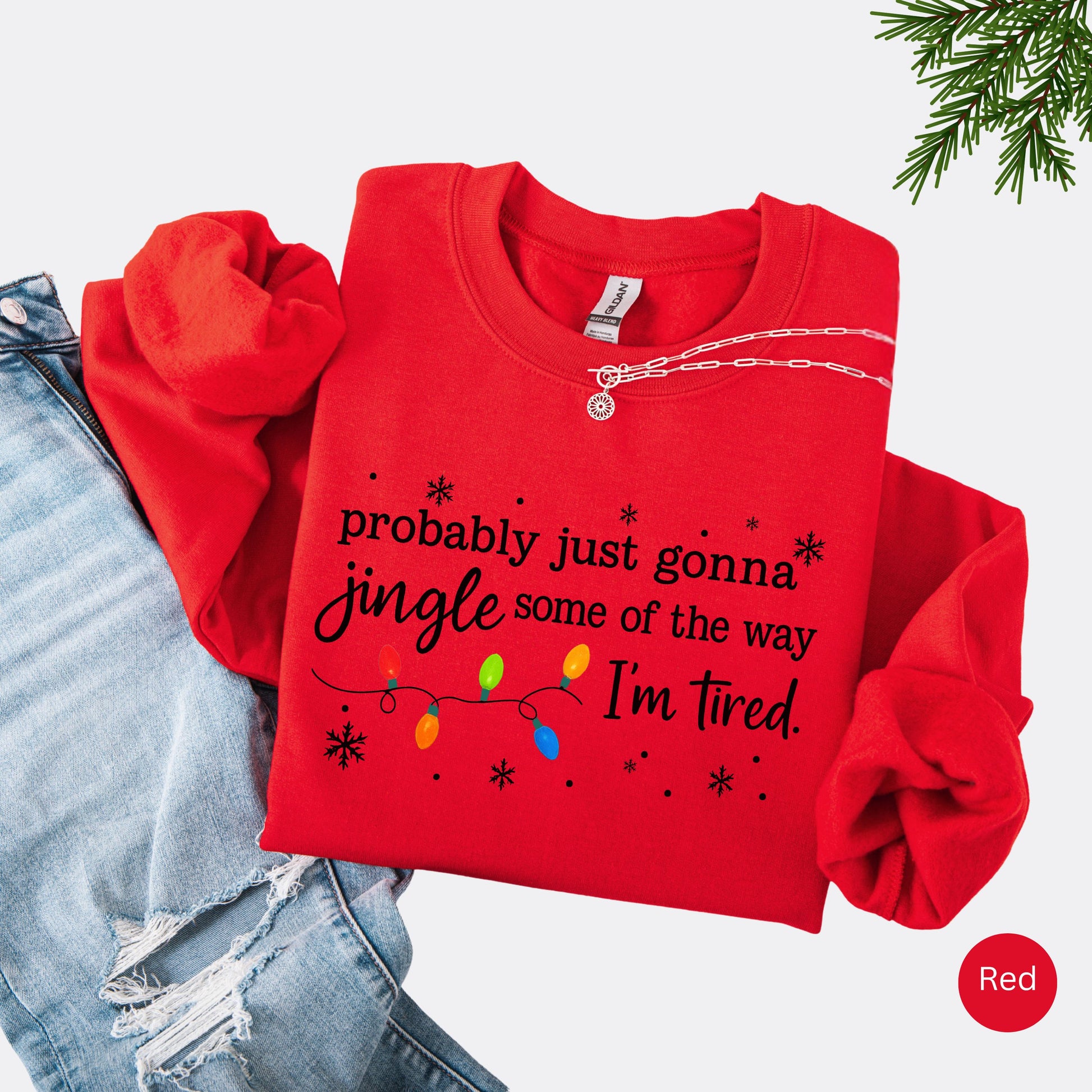 Red sweatshirt with Christmas lights and the text "probably just gonna jingle some of the way I'm tired".