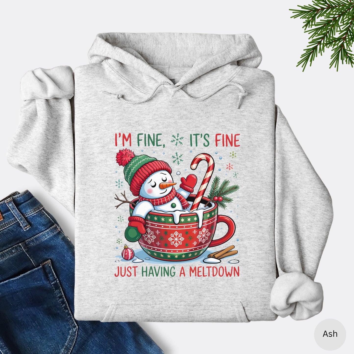 Snowman Christmas hoodie in the color ash with festive mug design and text that reads I’m Fine It’s Fine Just Having a Meltdown.