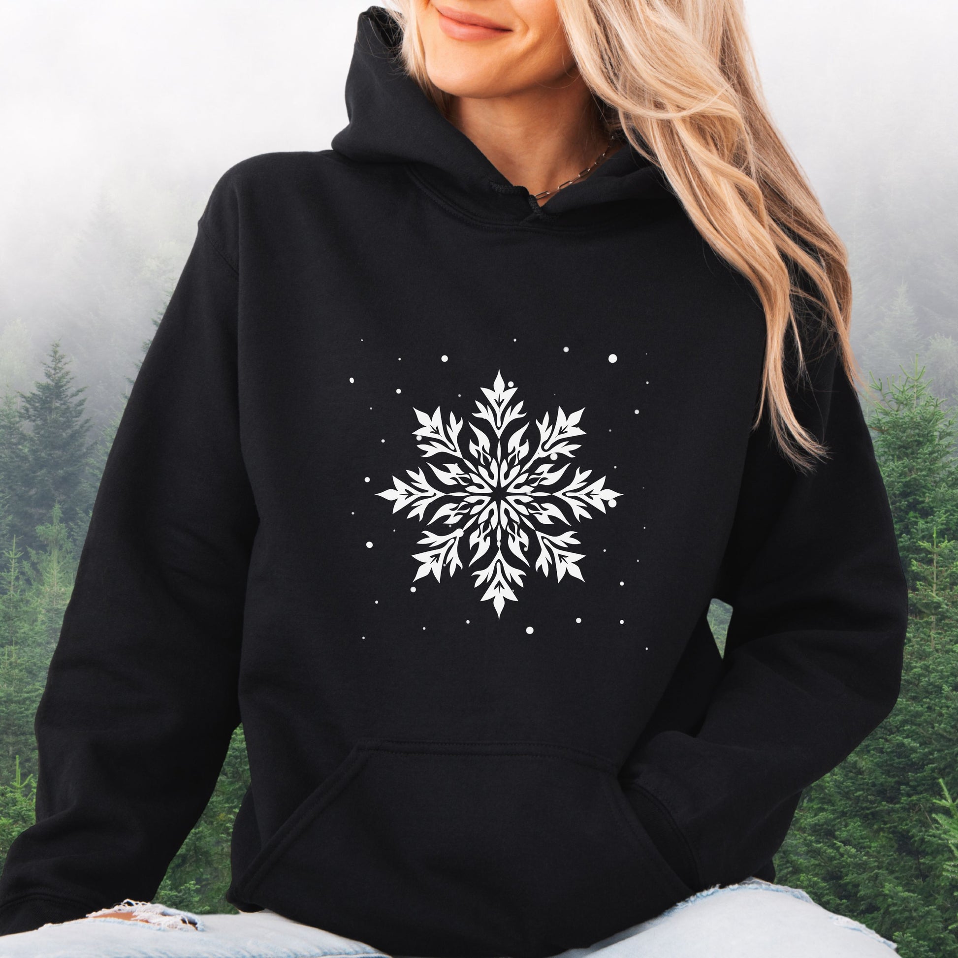Person wearing snowflake design with falling snow on cozy unisex hoodie in the color black