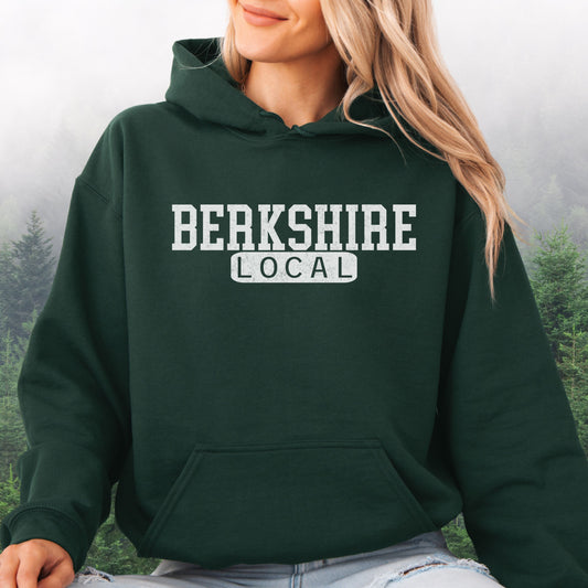 Person wearing Berkshire Local vintage distressed Massachusetts hoodie with collegiate lettering, forest green