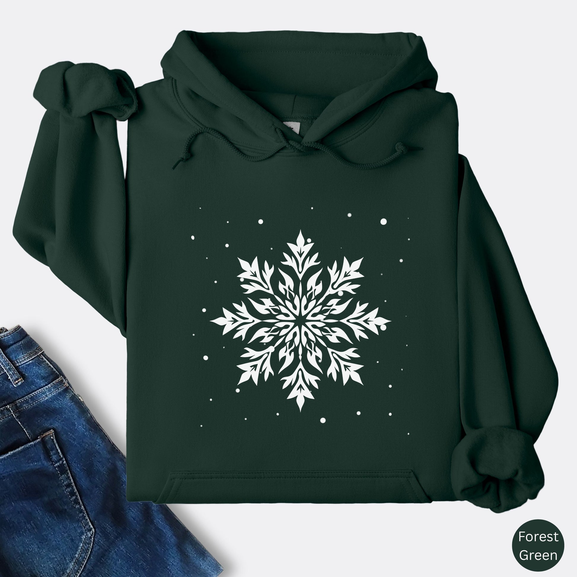 Snowflake design with falling snow on cozy unisex hoodie in the color forest green