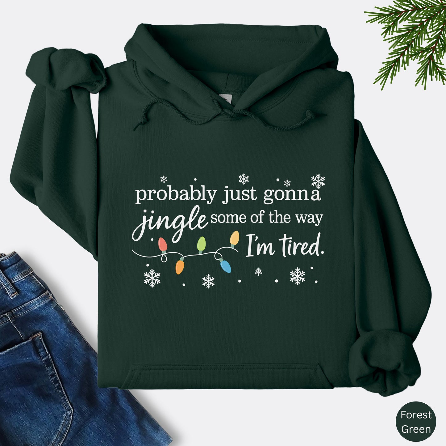 Forest green hoodie with Christmas lights and the text "probably just gonna jingle some of the way. I'm tired".
