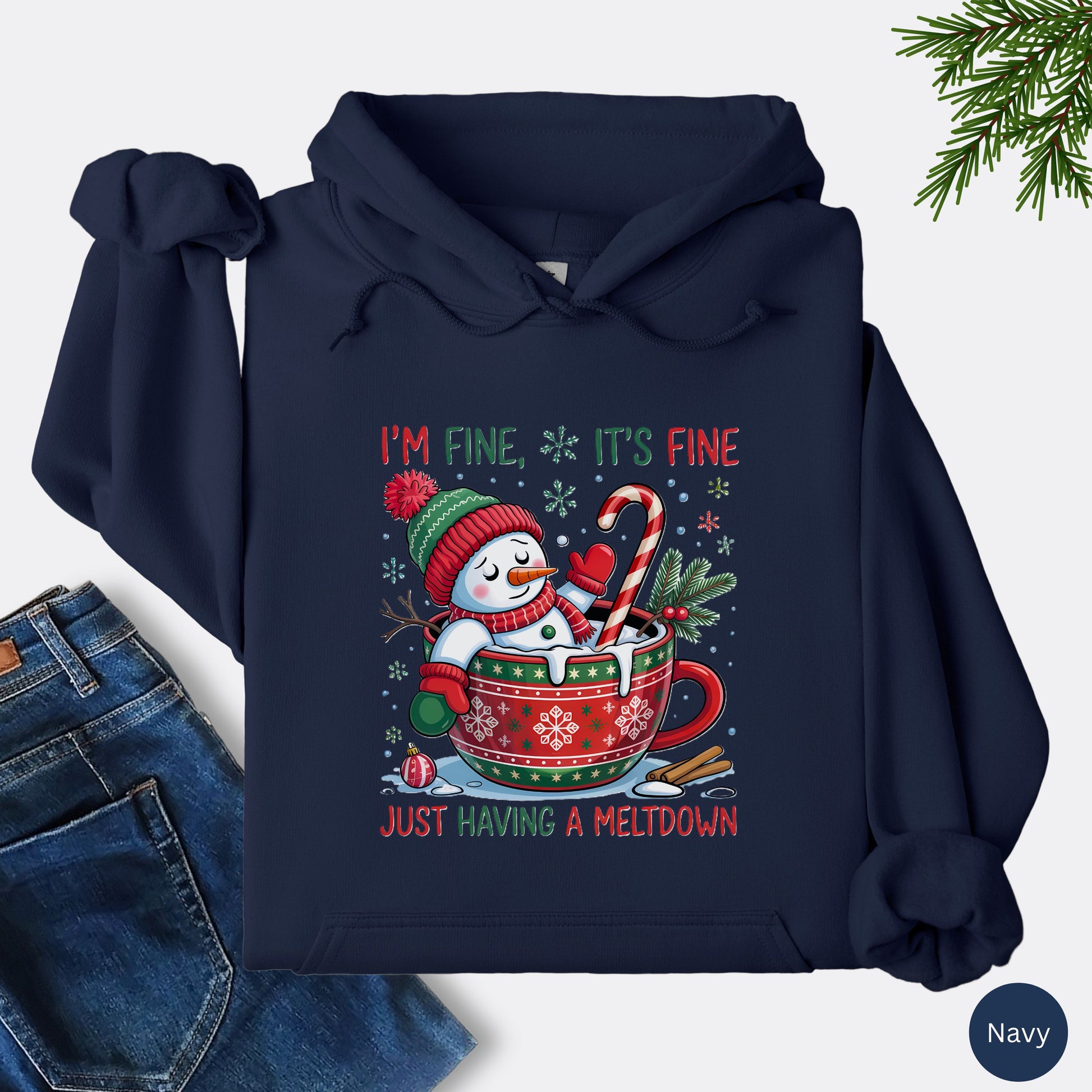 Snowman Christmas hoodie in the color navy with festive mug design and text that reads I’m Fine It’s Fine Just Having a Meltdown.