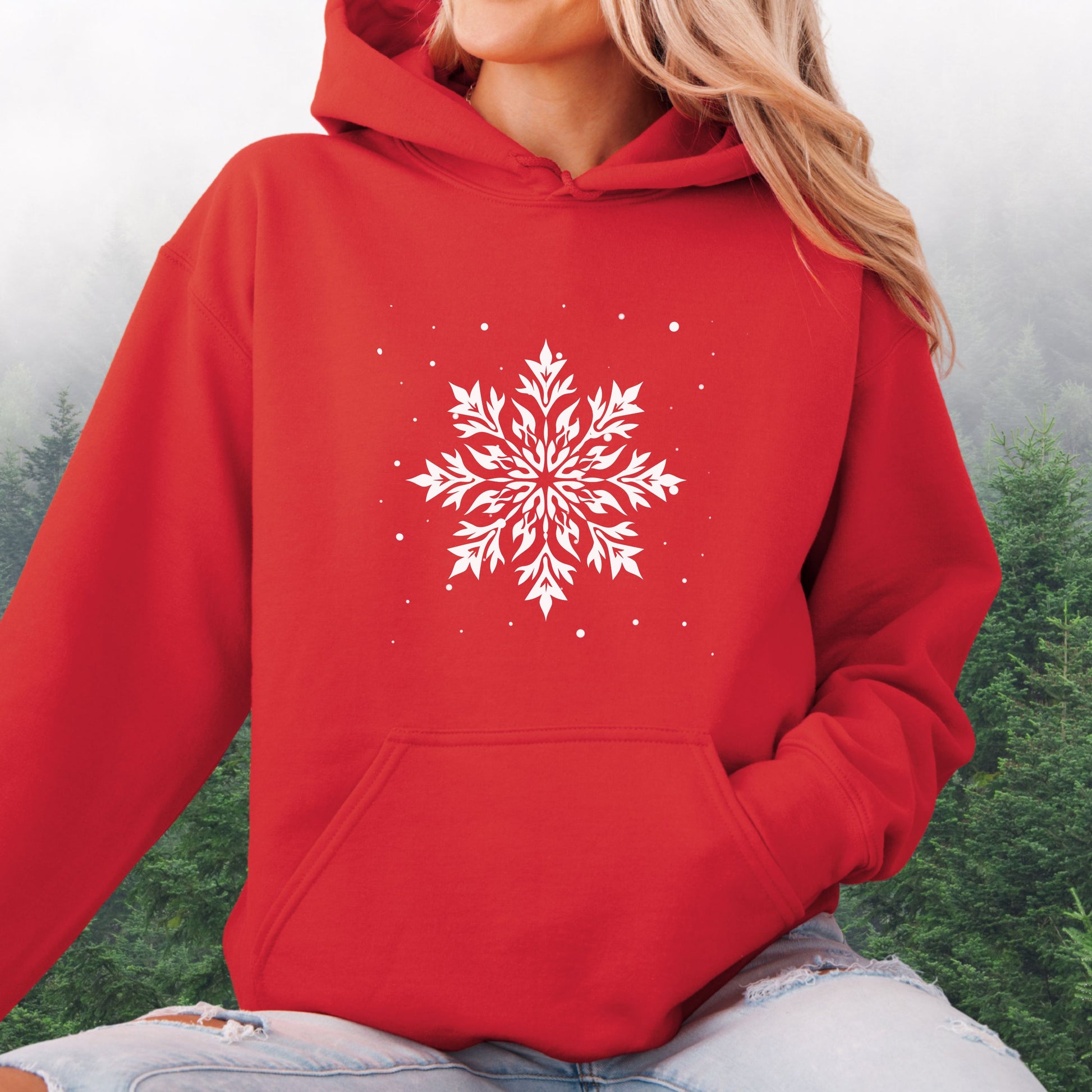 Person wearing snowflake design with falling snow on cozy unisex hoodie in the color red