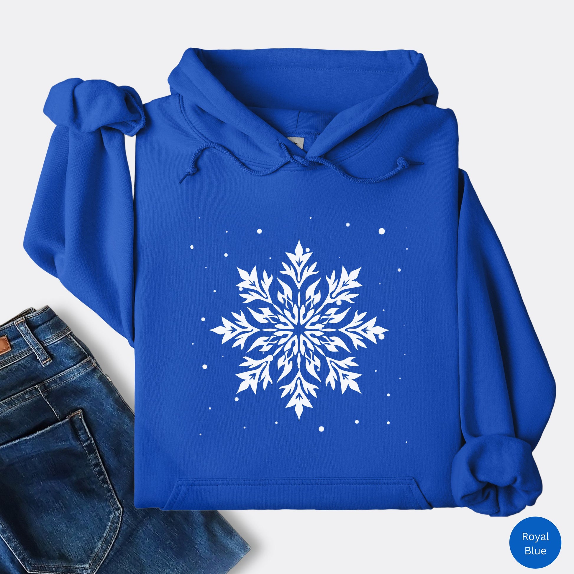 Snowflake design with falling snow on cozy unisex hoodie in the color royal blue