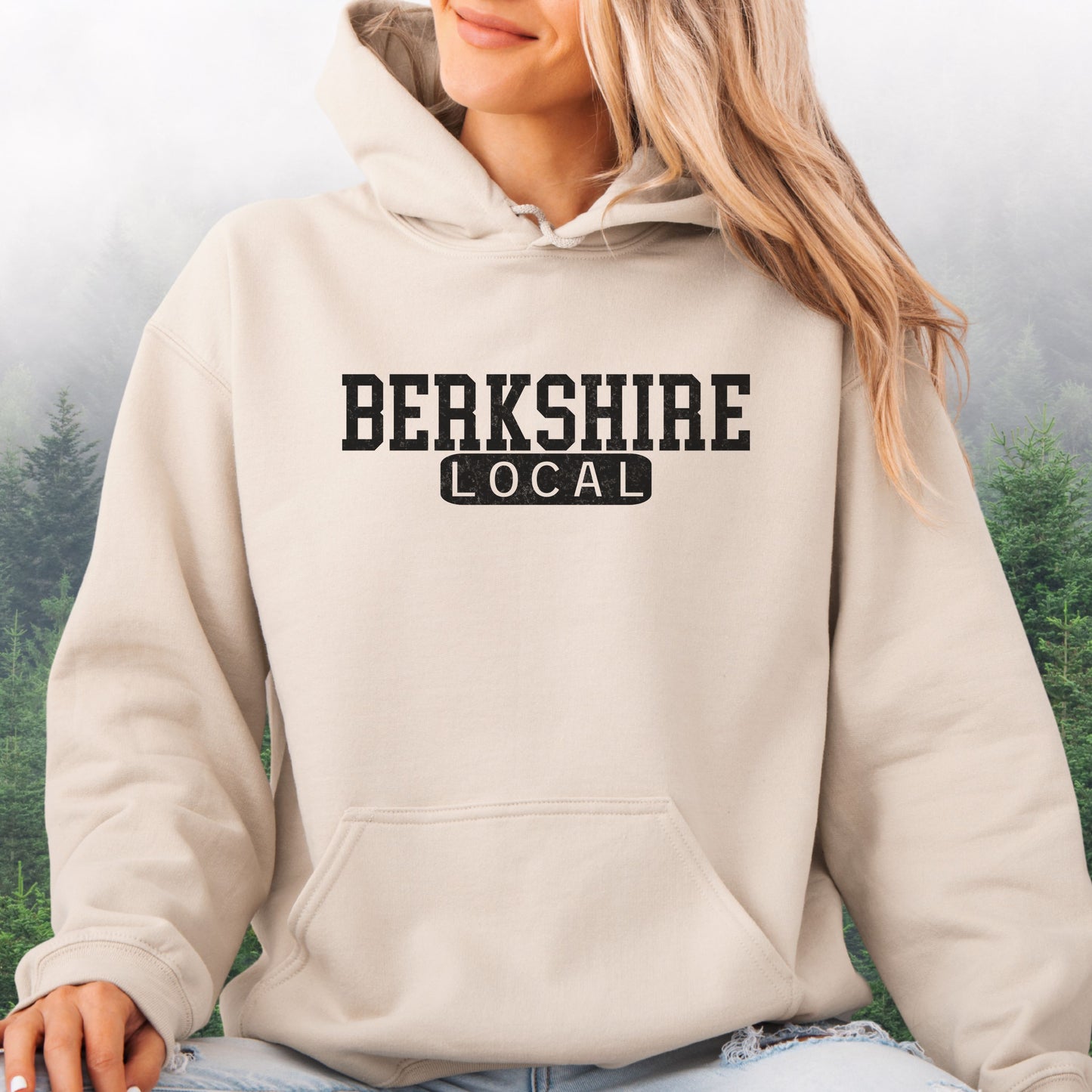 Person wearing Berkshire Local vintage distressed Massachusetts hoodie with collegiate lettering in the color sand