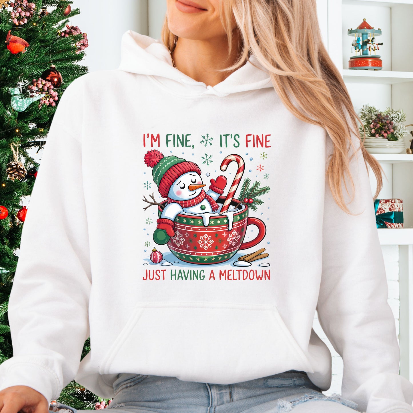 Person wearing white Snowman Christmas hoodie with festive mug design and text that reads I’m Fine It’s Fine Just Having a Meltdown.