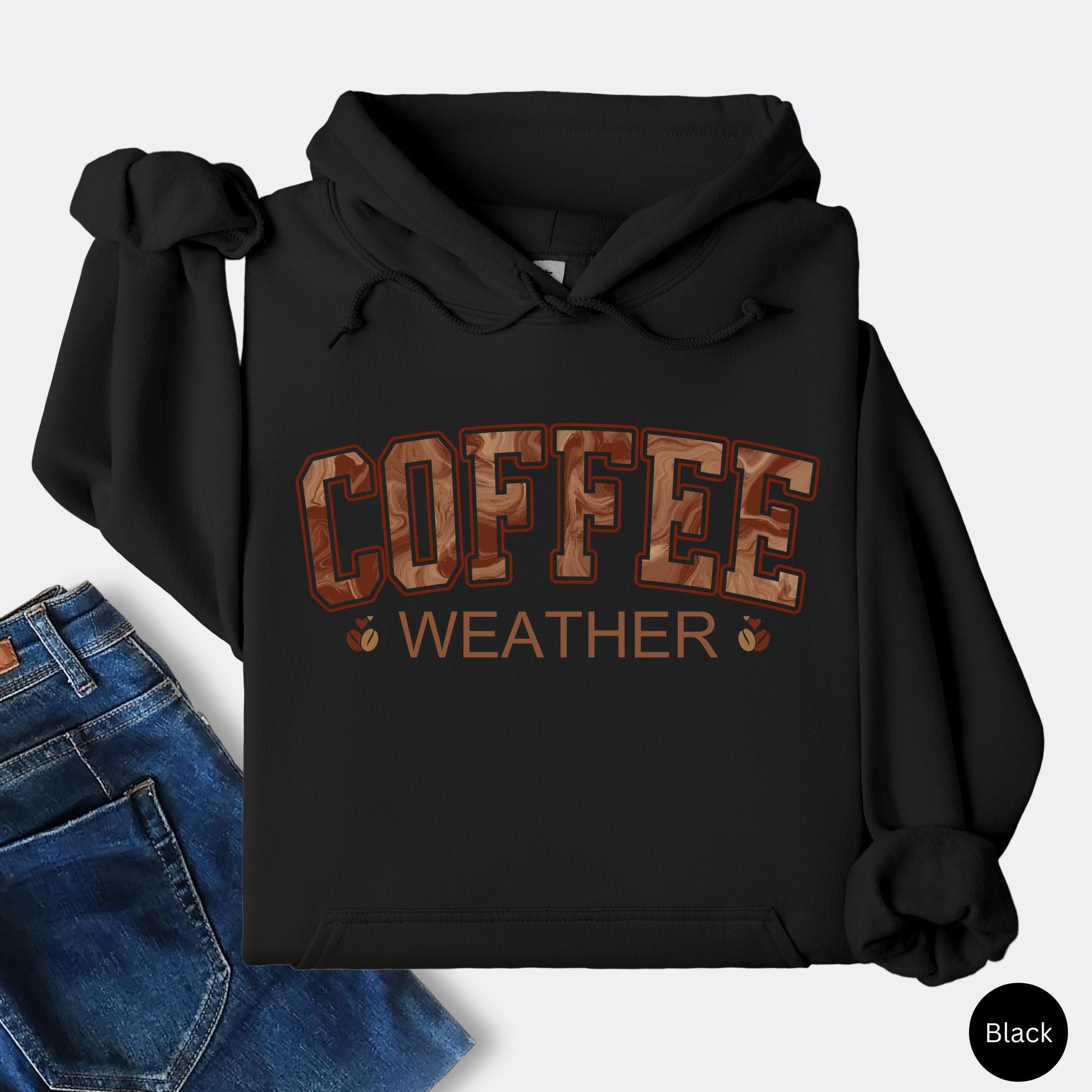 Black coffee weather hoodie with marbled brown lettering and coffee bean icons.