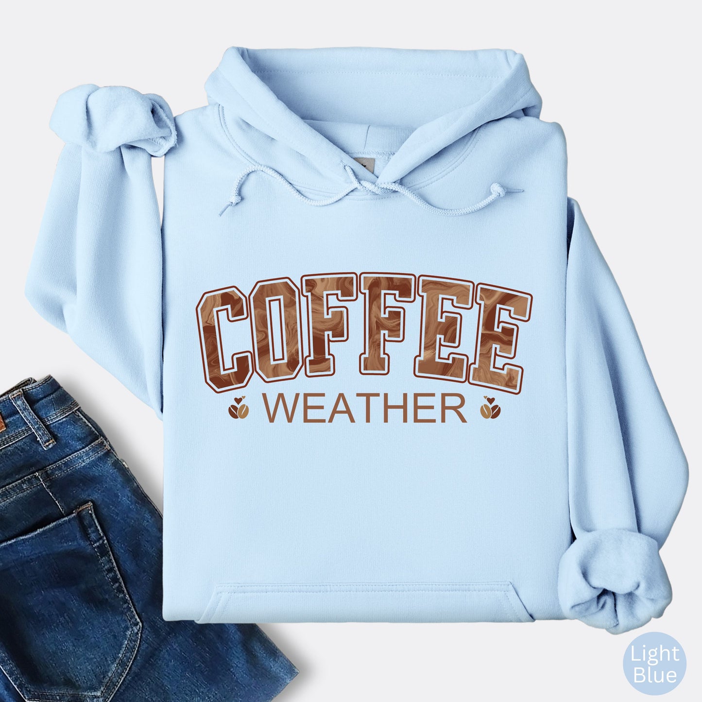 Light Blue colored coffee weather hoodie with marbled brown lettering and coffee bean icons.