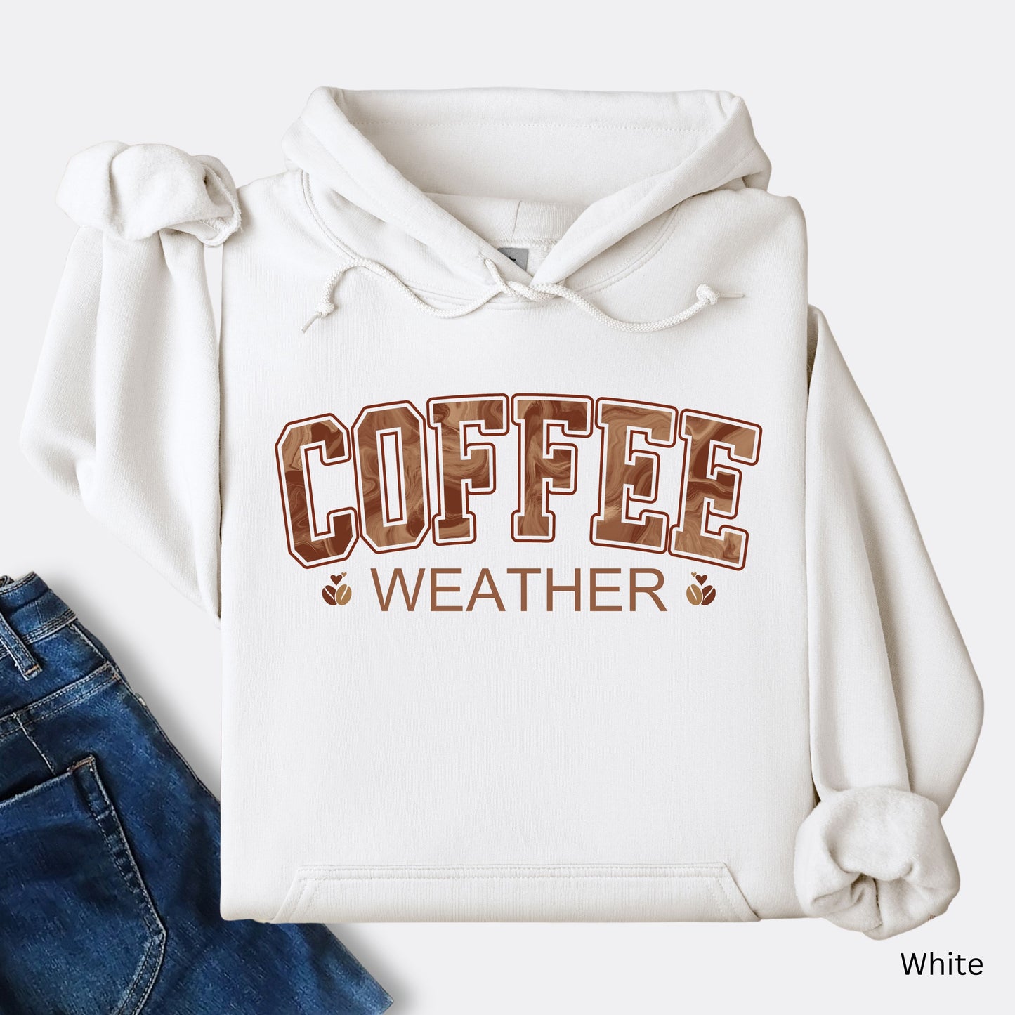 White coffee weather hoodie with marbled brown lettering and coffee bean icons.