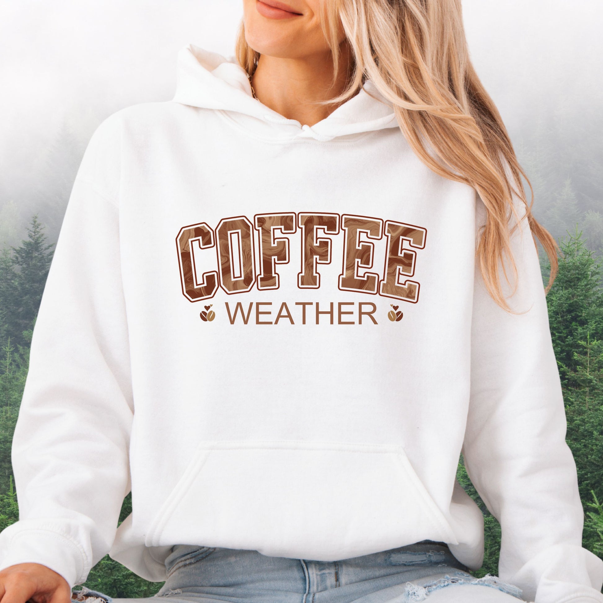 Person wearing white coffee weather hoodie with marbled brown lettering and coffee bean icons.