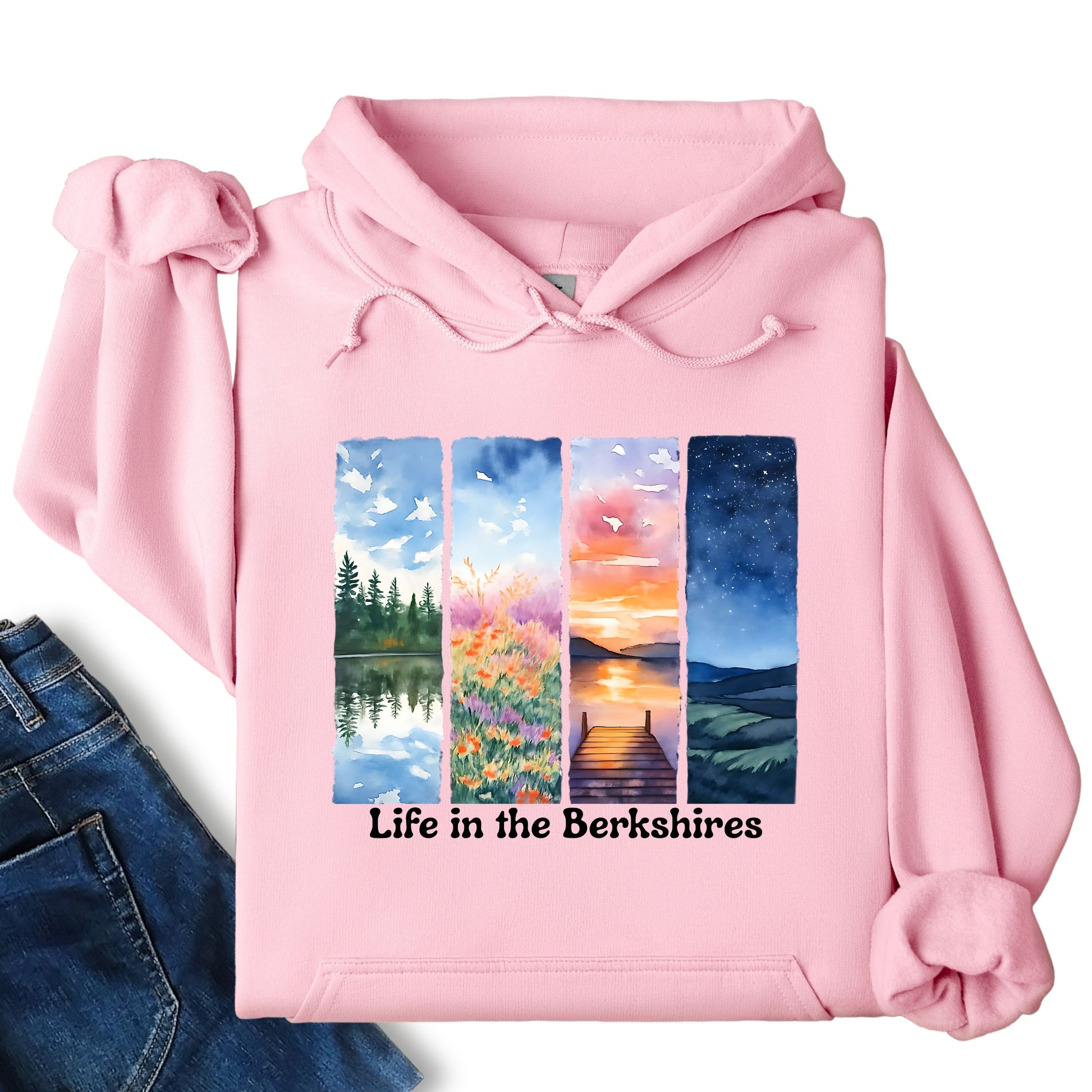 Life in the Berkshires hoodie laid flat showing scenic landscape panel graphic on the front in light pink