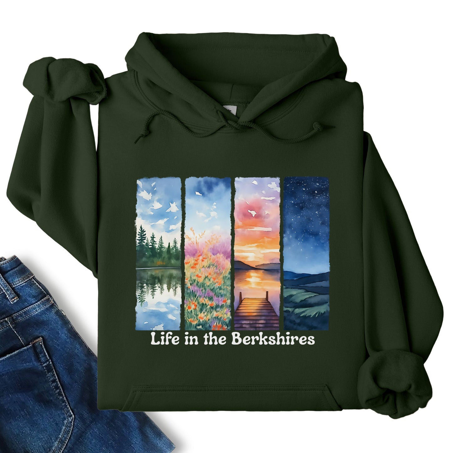 Life in the Berkshires hoodie laid flat showing scenic landscape panel graphic on the front in forest green