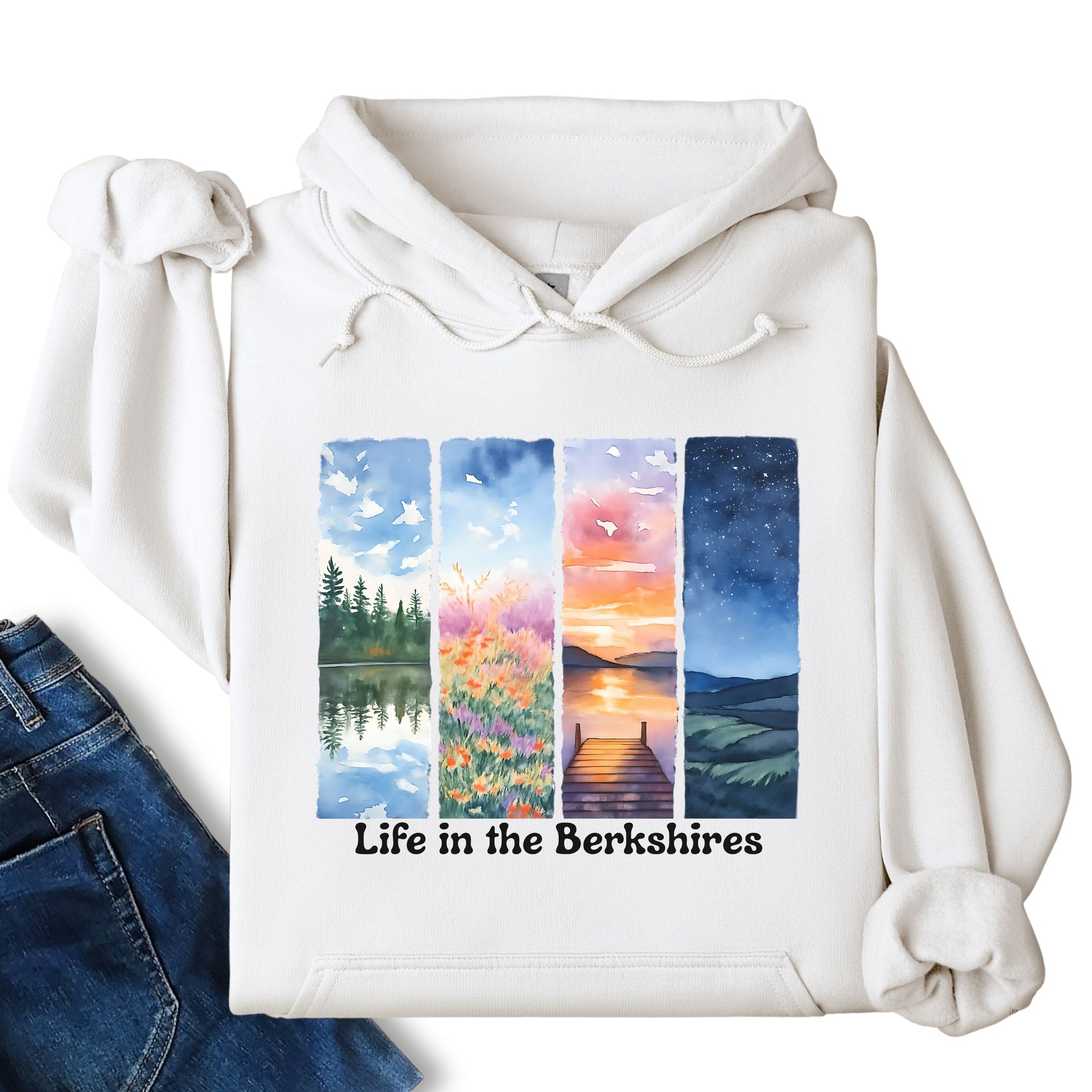 Life in the Berkshires hoodie laid flat showing scenic landscape panel graphic on the front in white