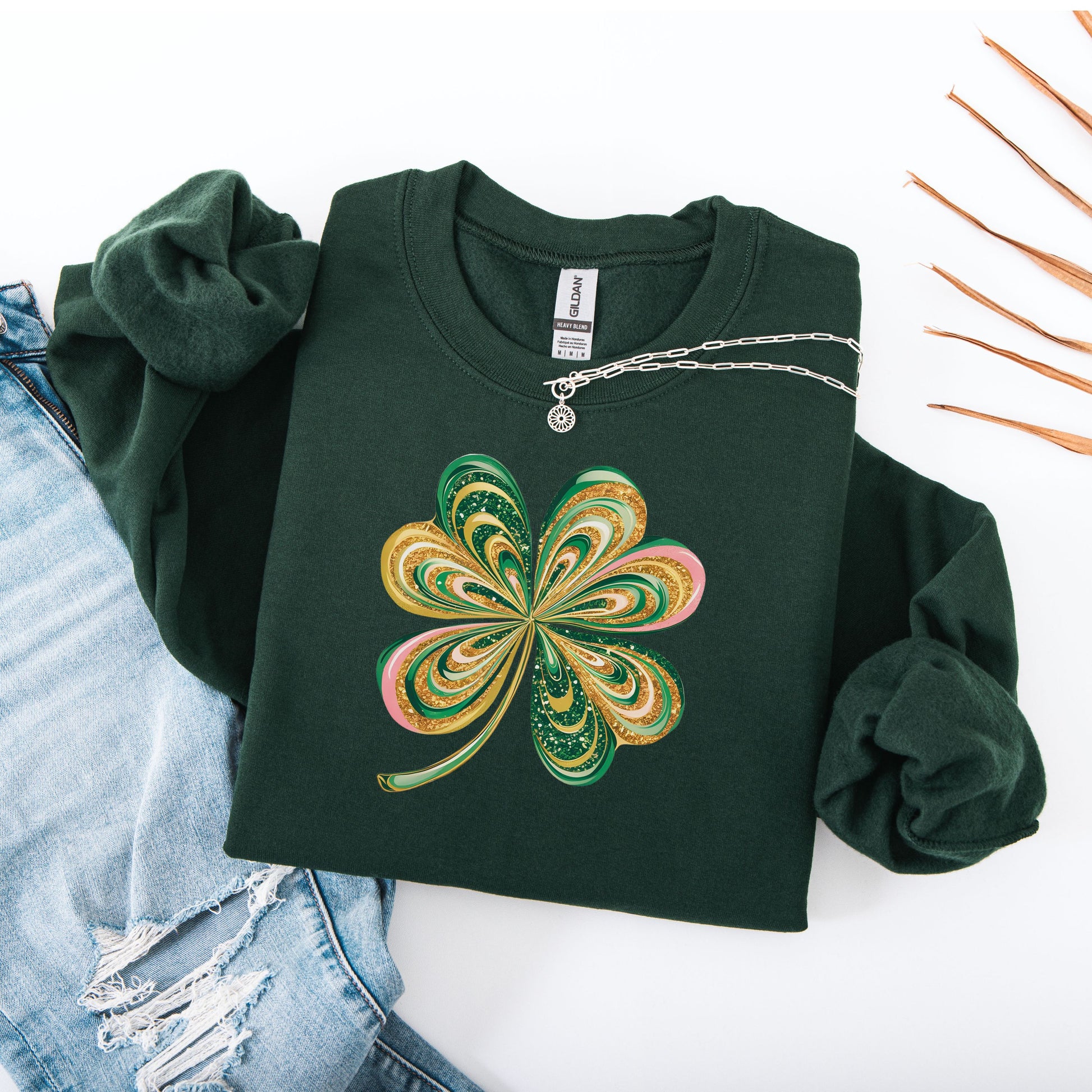 Retro shamrock design on Gildan forest green sweatshirt flat lay