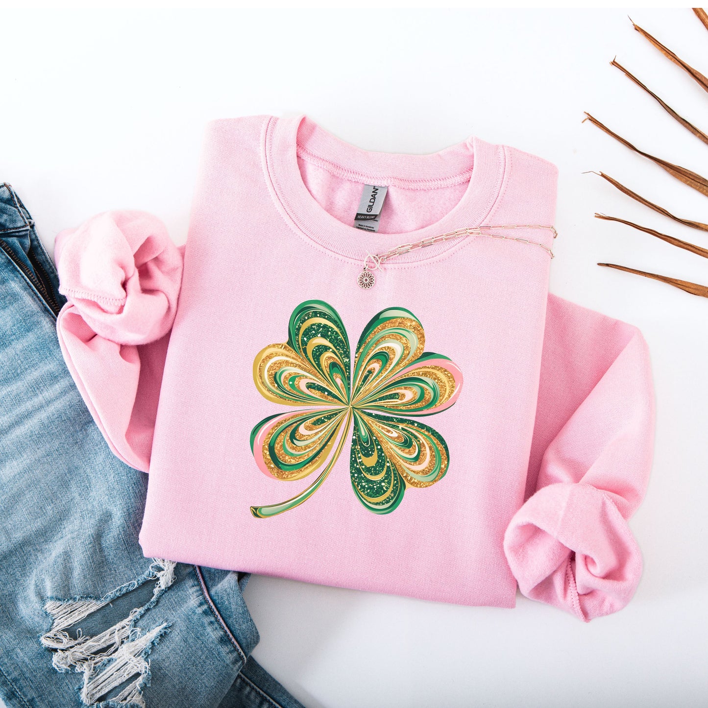 Retro shamrock design on Gildan light pink sweatshirt flat lay