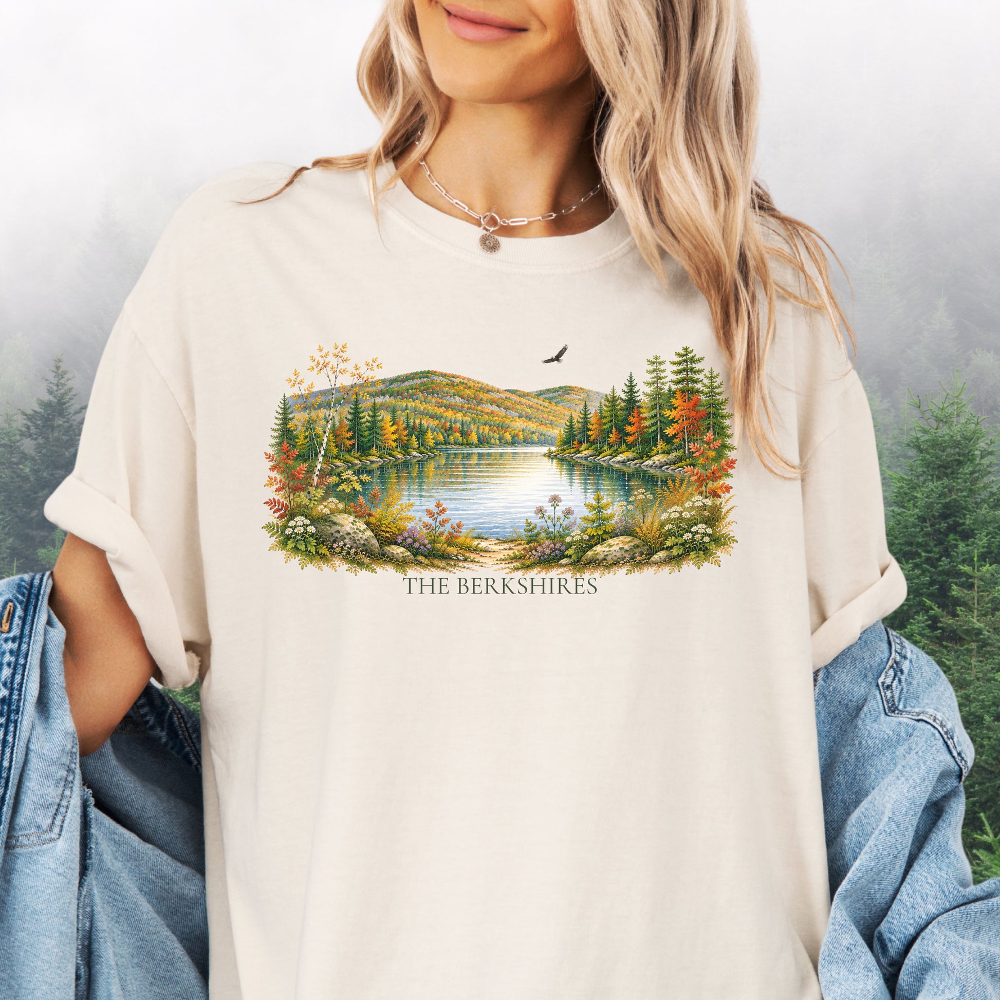 Person wearing The Berkshires autumn landscape Comfort Colors T-shirt with colorful fall foliage, mountains, lake and eagle in the color ivory.